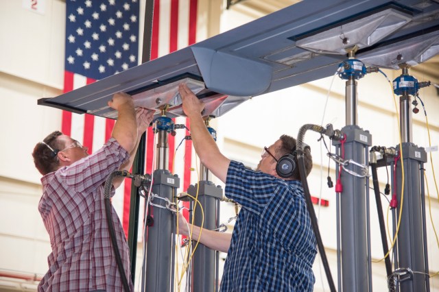 Jacob Roepel and Aaron Rumsey set the load pads for the calibration research wing, or CREW.