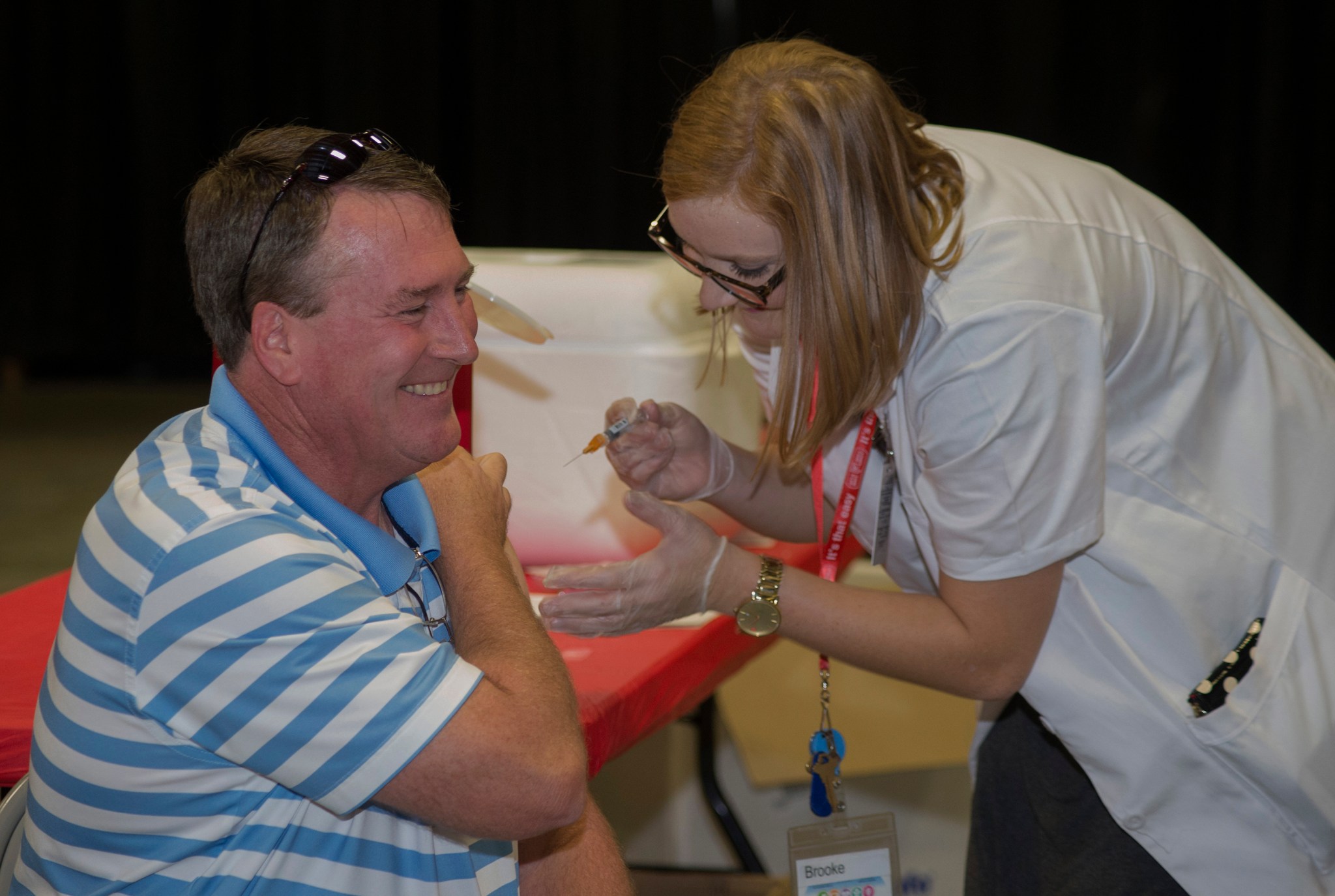 Walgreens pharmacist Brooke McGee, right, administers a flu shot to Marshall engineer Robert Rutherford in Building 4316.