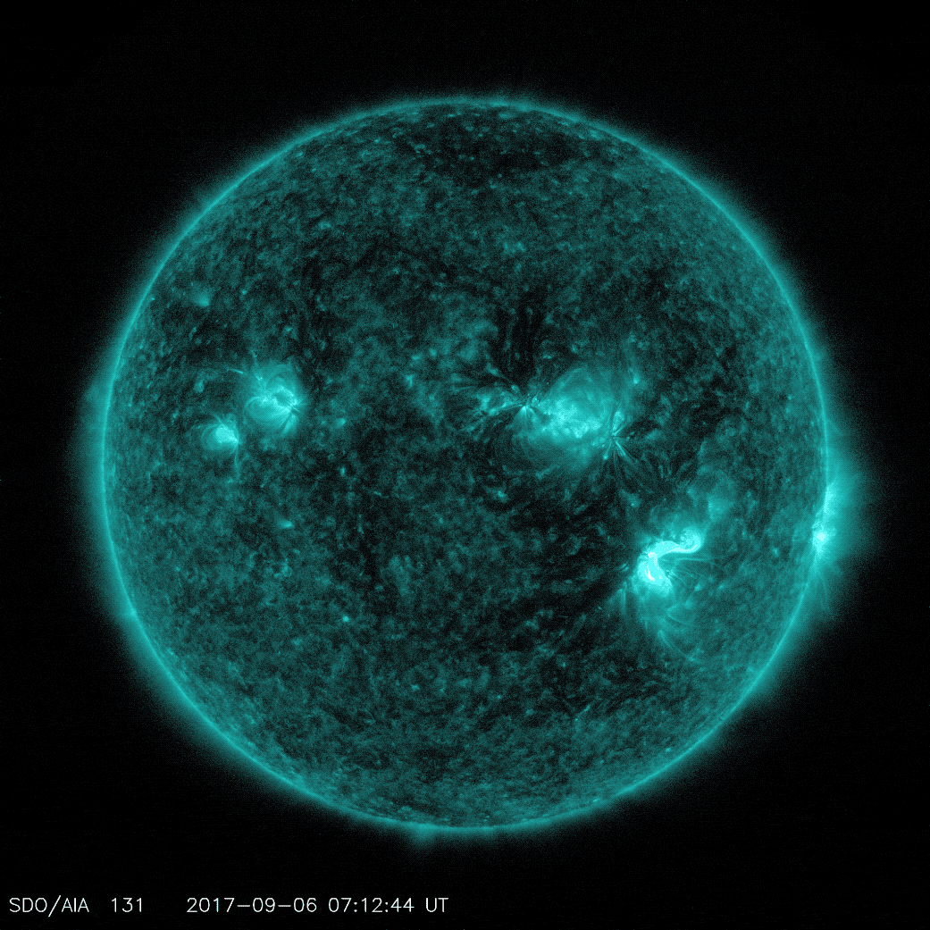 Satellite image of the Sun, colorized to look turquoise. The Sun rotates slightly, with one frame flashing the whole image turquoise.