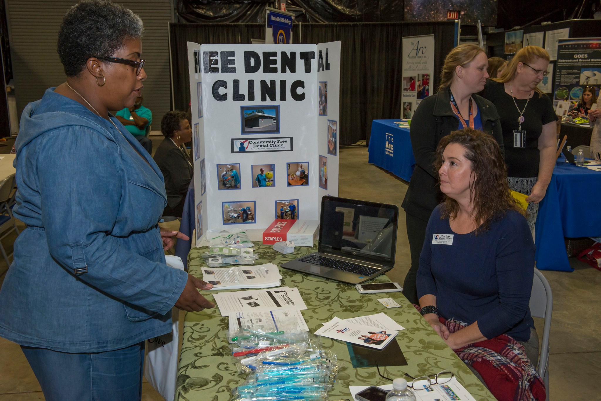 Gabrall Yeldell, of the Office of Communications and CFC keyworker, listens as Julia Nabors of the Free Dental Clinic of Madison