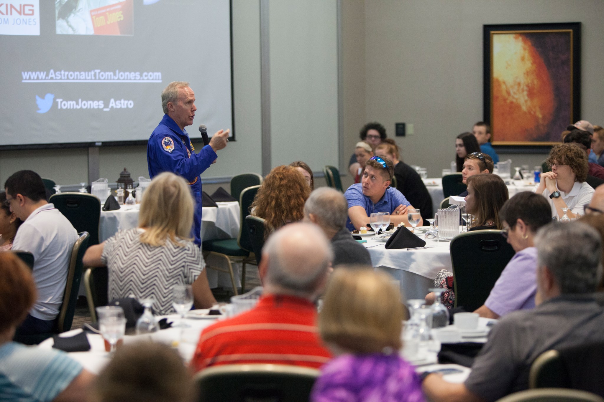 Retired NASA astronaut Tom Jones talks to high school students during lunch at Kennedy Space Center Visitor Complex in Florida.