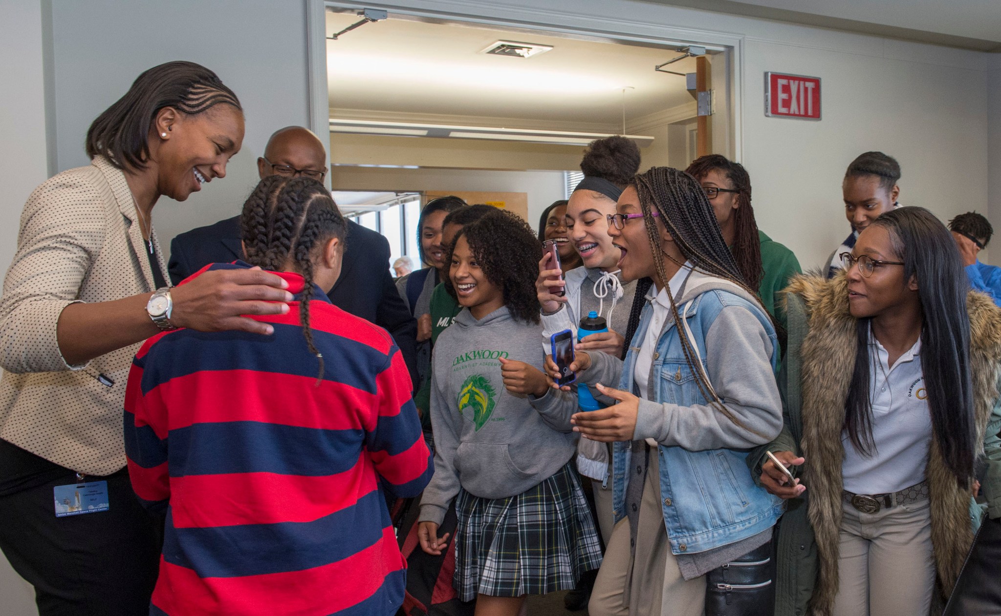 Tamika Catchings, left, greets members of the girls' basketball team from Oakwood Adventist Academy Oct. 31.
