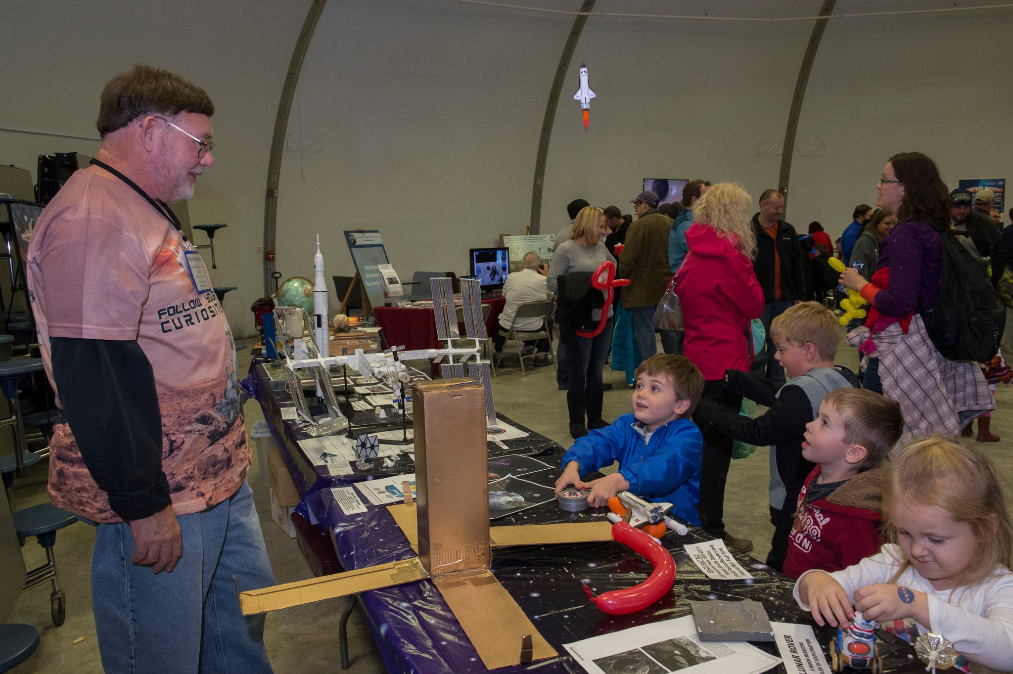A group of children participate in an exhibit at the U.S. Space & Rocket Center.