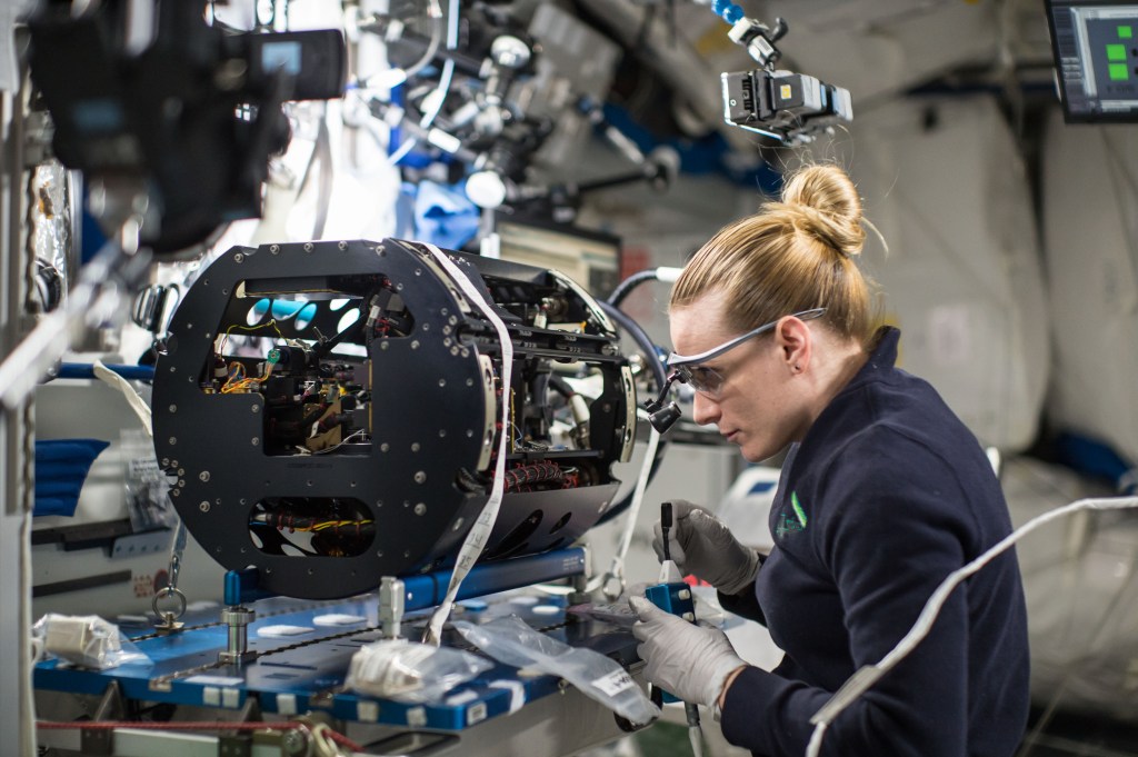 astronaut Kate Rubins next to MDCA facility