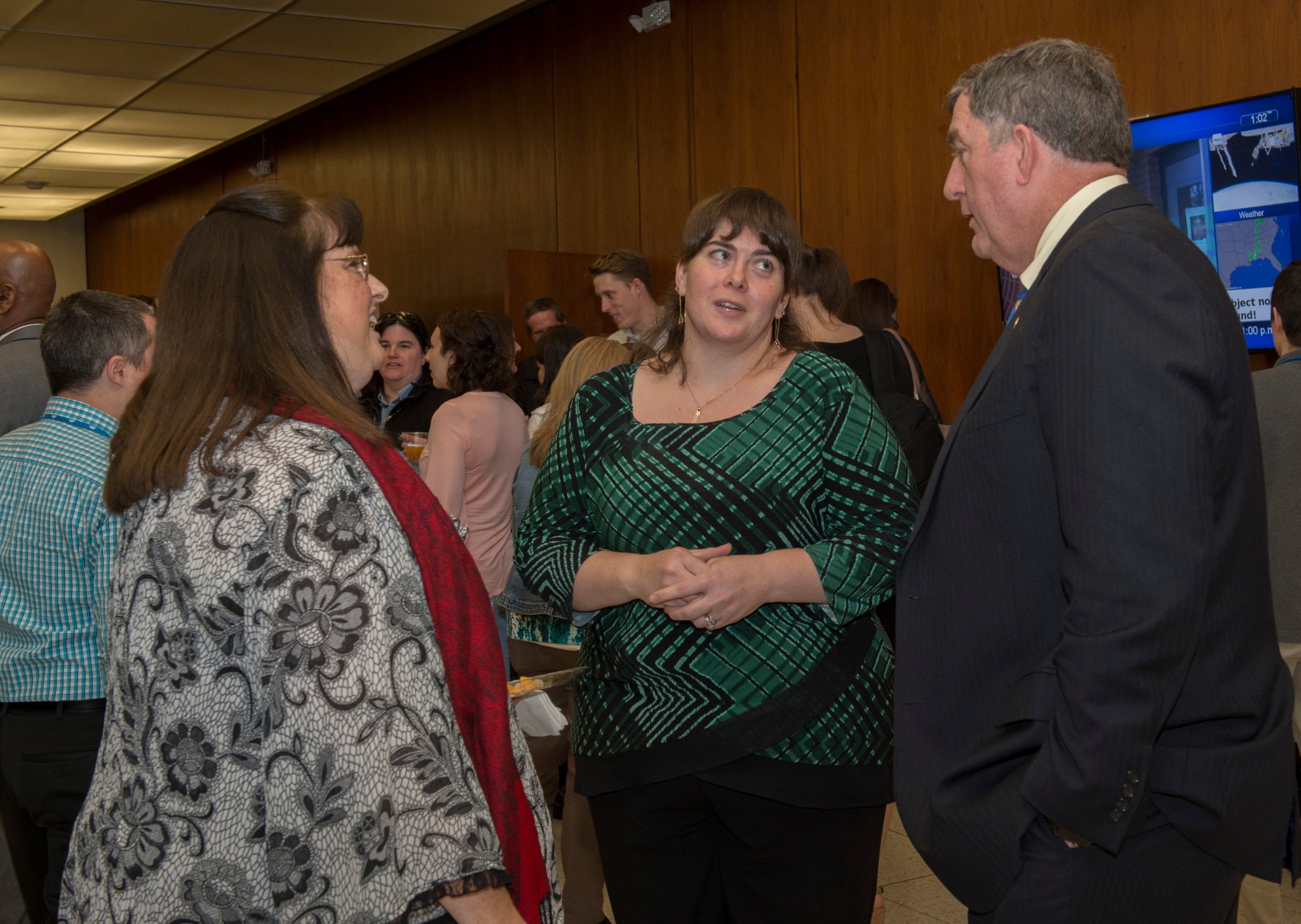 International Space Station Program Manager Kirk Shireman, right, chats with Victoria Stewart and C.J. Marroquin.