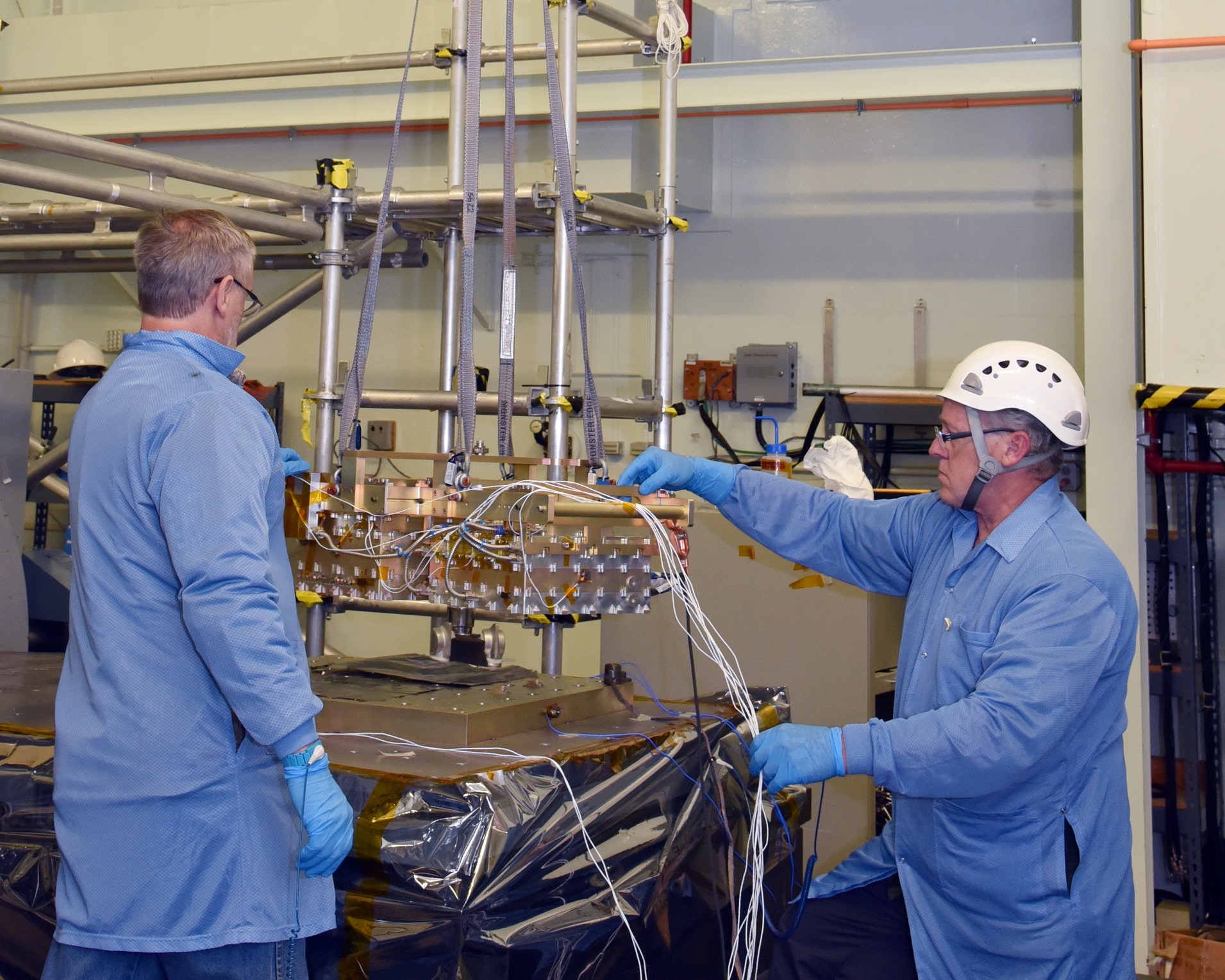 LCRD engineers prepare Flight Modem 2 for vibration testing.