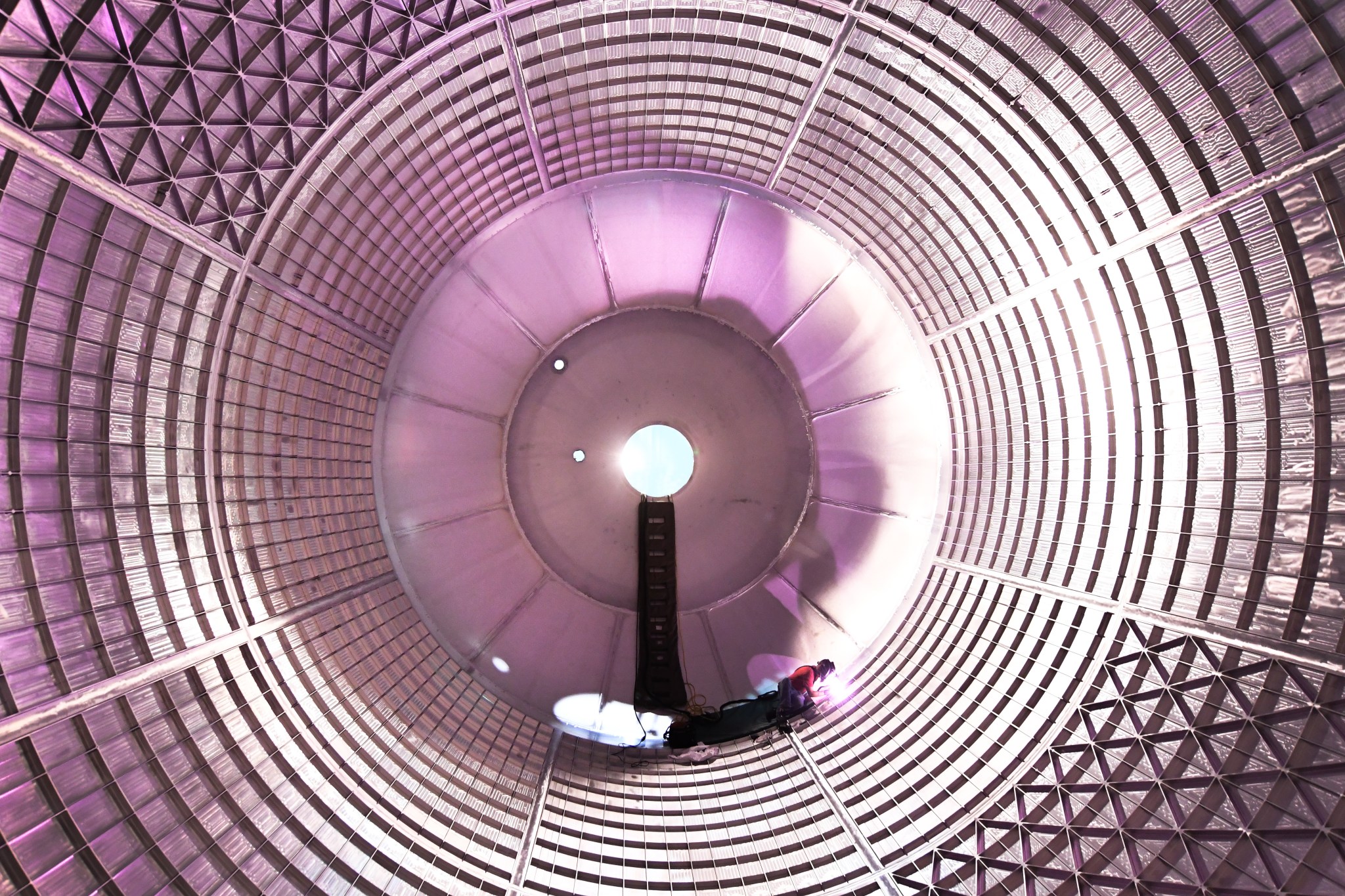 The liquid oxygen tank--shown here as technicians inside the tank complete final welds to plug holes left by the robotic welder.