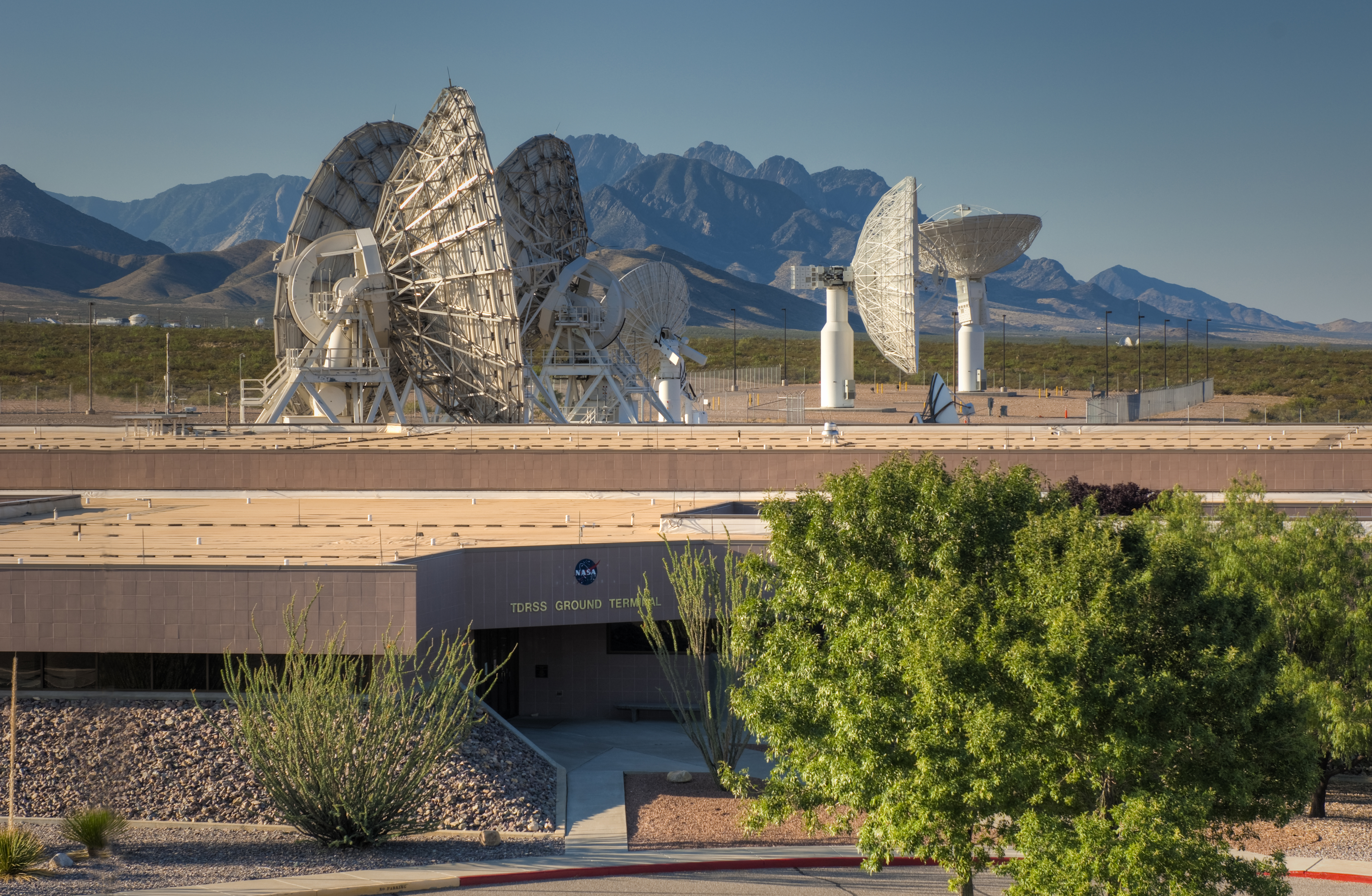 TDRSS ground station with satellite dishes and mountains in the background at WSTF