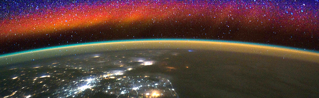 The lowest reaches of space glow with bright bands of color called airglow in this image
