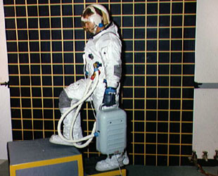 Astronaut John Bull demonstrates the flexibility of the new suit .