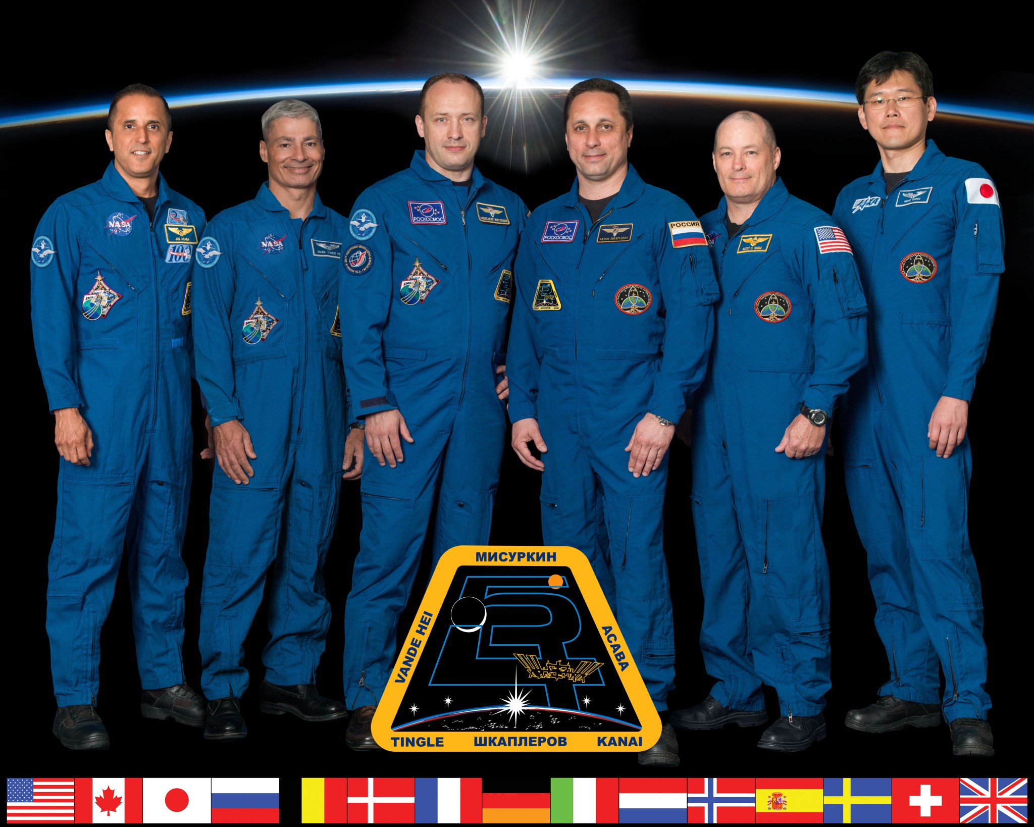 Six crew members of Expedition 54 pose with their mission patch