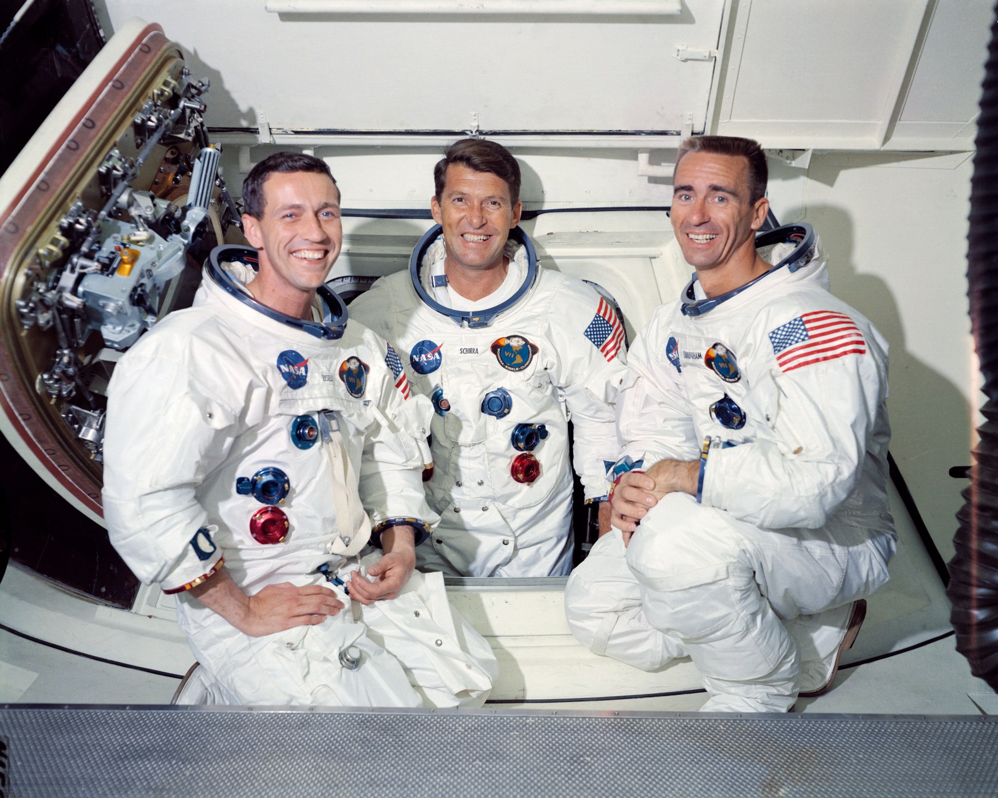 Portrait of three Apollo 7 astronauts in spacesuits