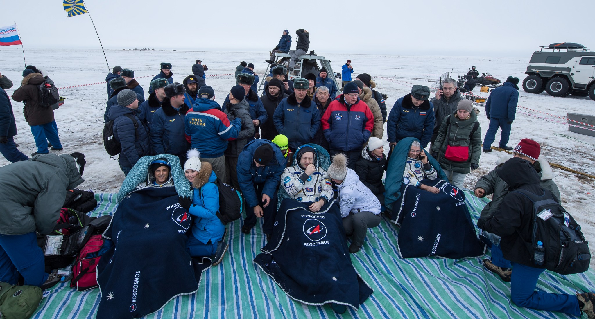 Astronauts and cosmonaut with ground crew after Soyuz landing