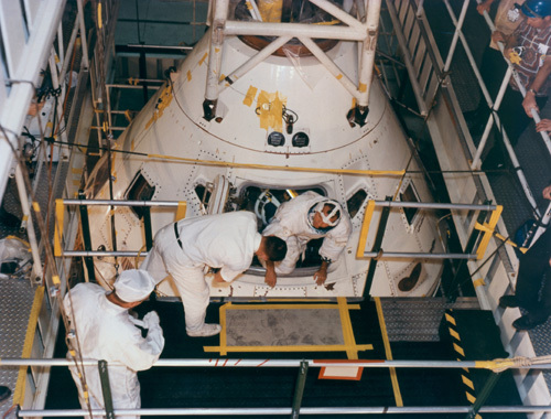 Astronaut Gordon Cooper emerges from CSM-105