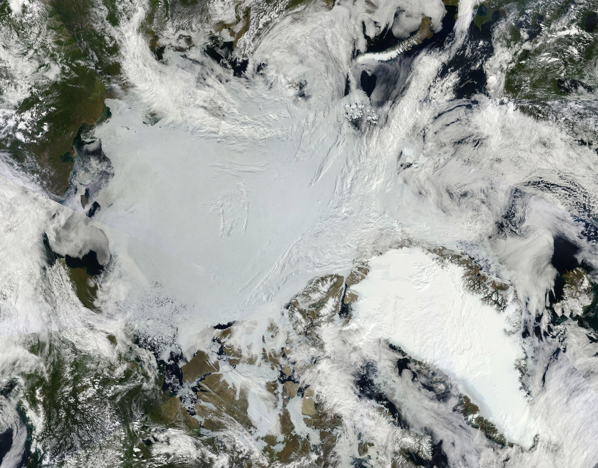 2011 composite satellite image shows the expanse of Arctic sea ice (center) and the Greenland Ice Sheet (lower right)