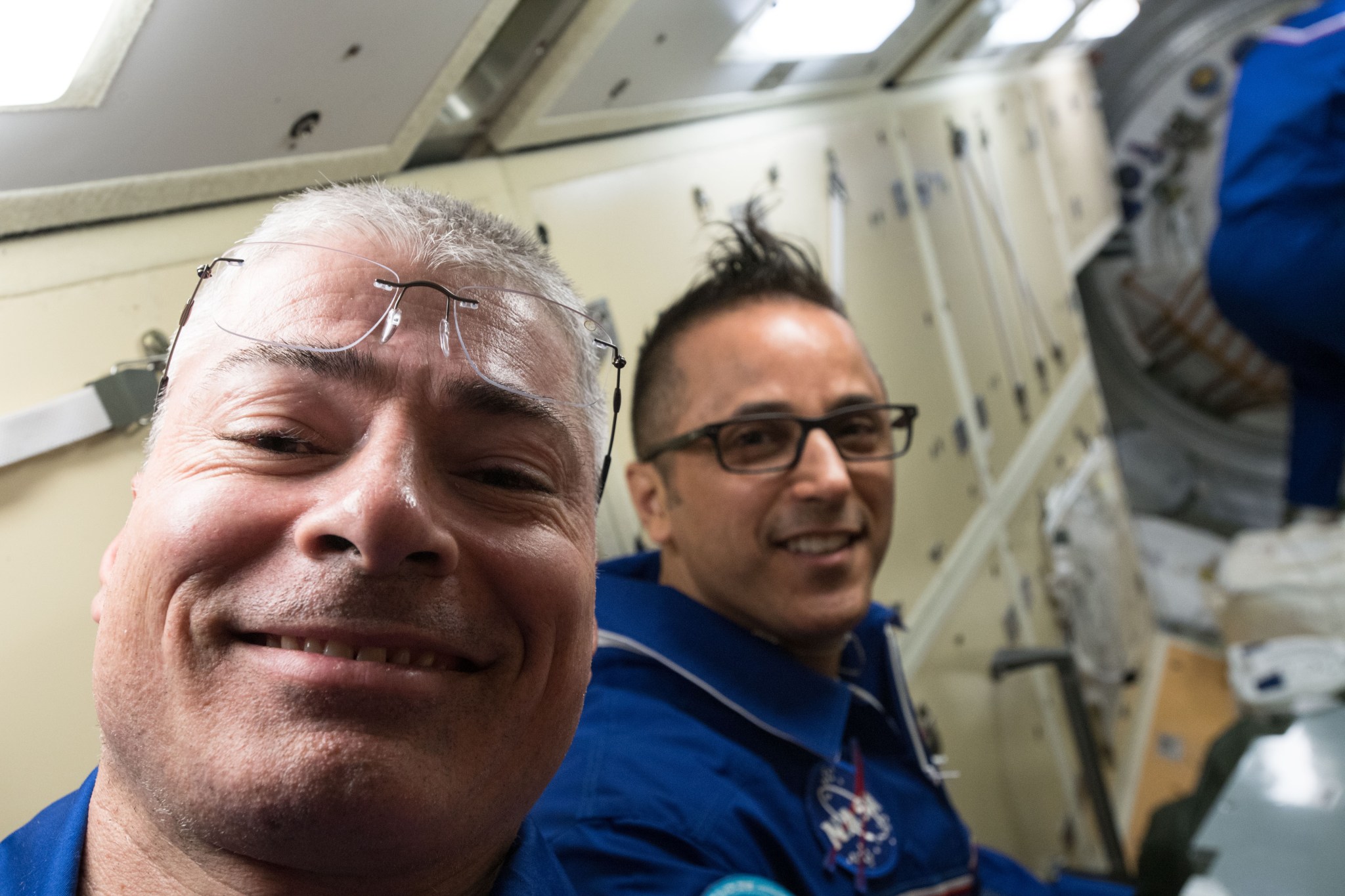 Flight Engineers Mark Vande Hei and Joe Acaba pose for a photo as they await hatch opening with the docked Soyuz spacecraft.