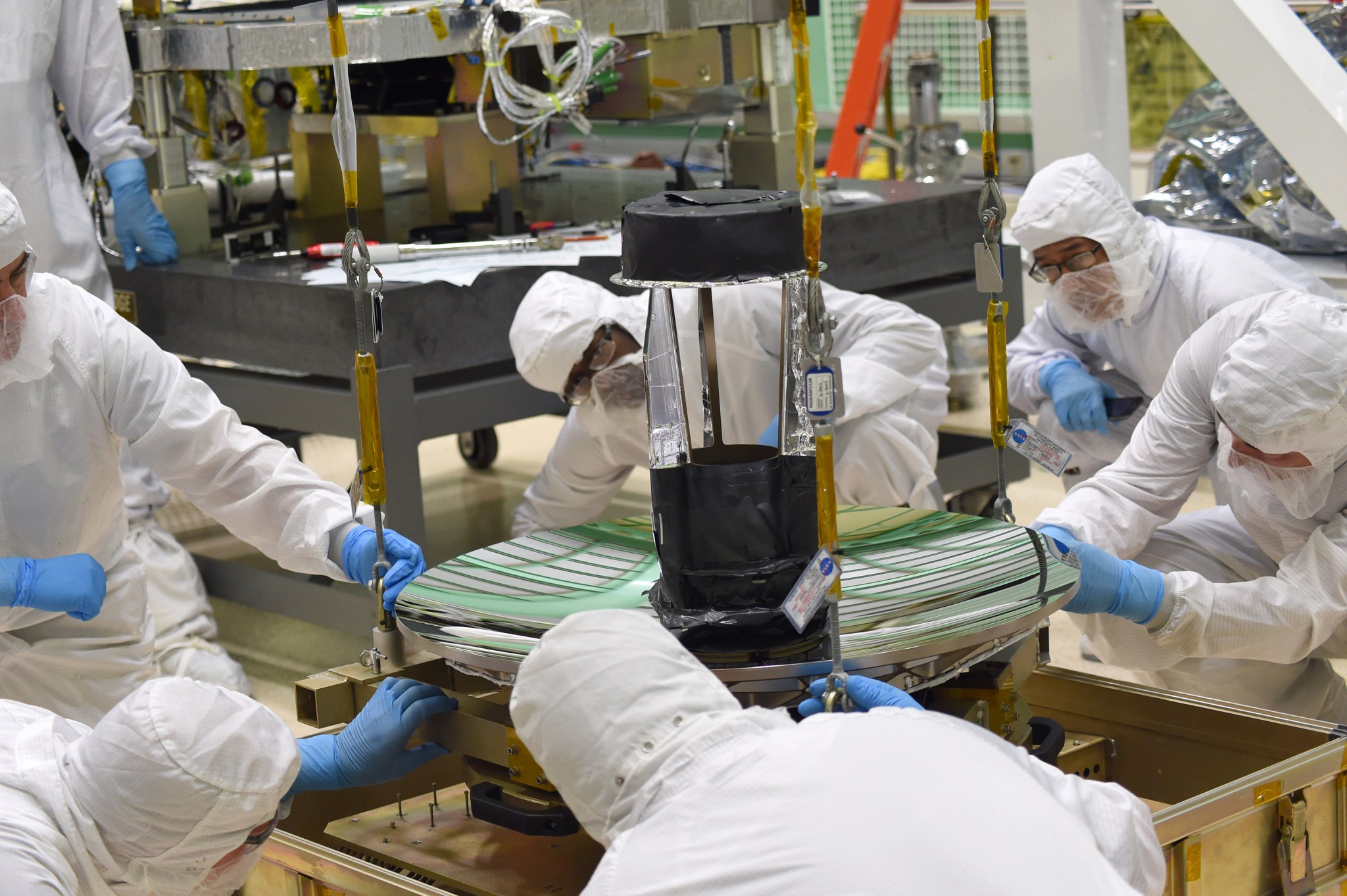 Engineers and technicians check the fit of ICESat-2's telescope to its sling at Goddard Space Flight Center.