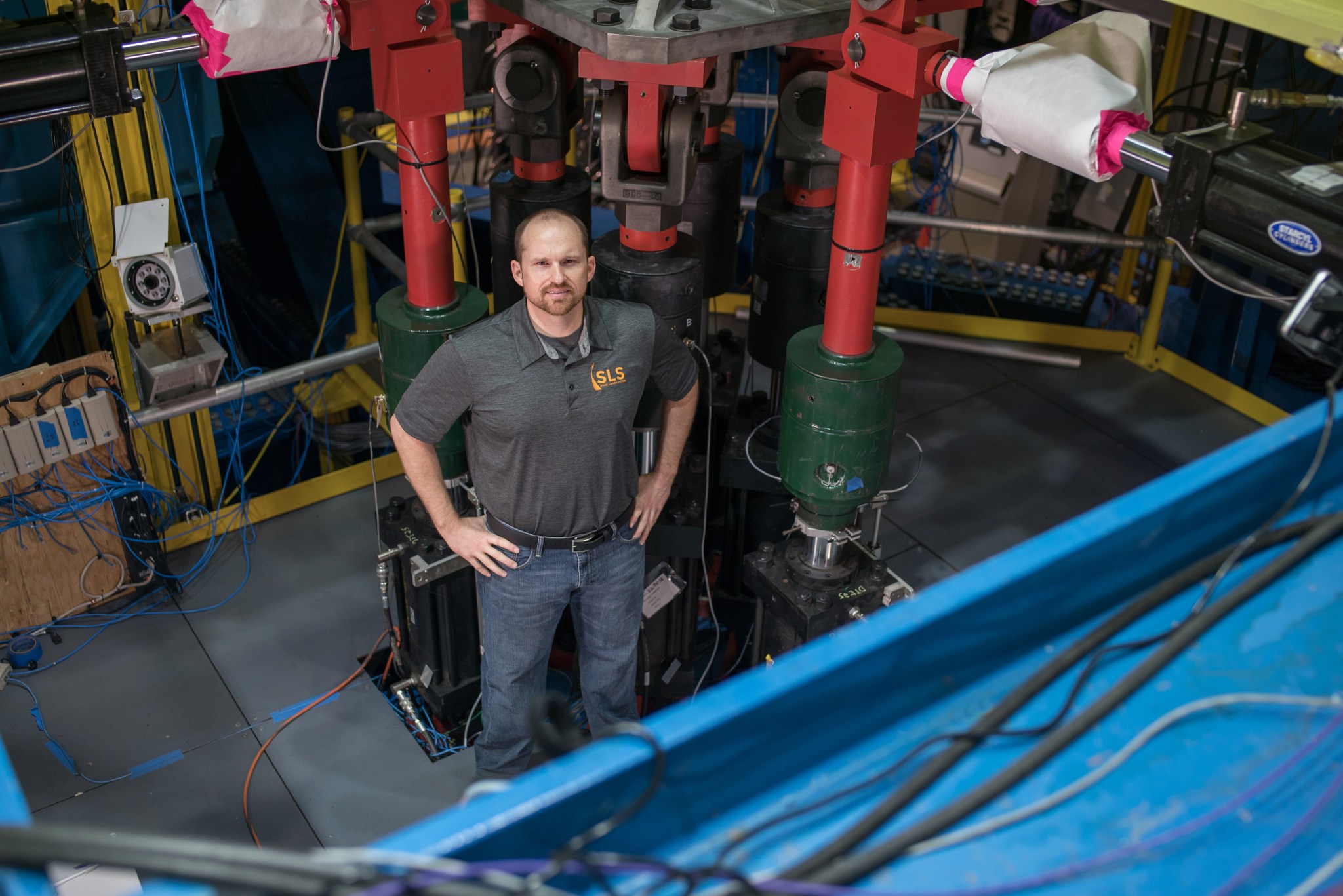 Mark White, engineer for the SLS core stage engine section, with actuators that simulated one of the rocket's four RS-25 engines