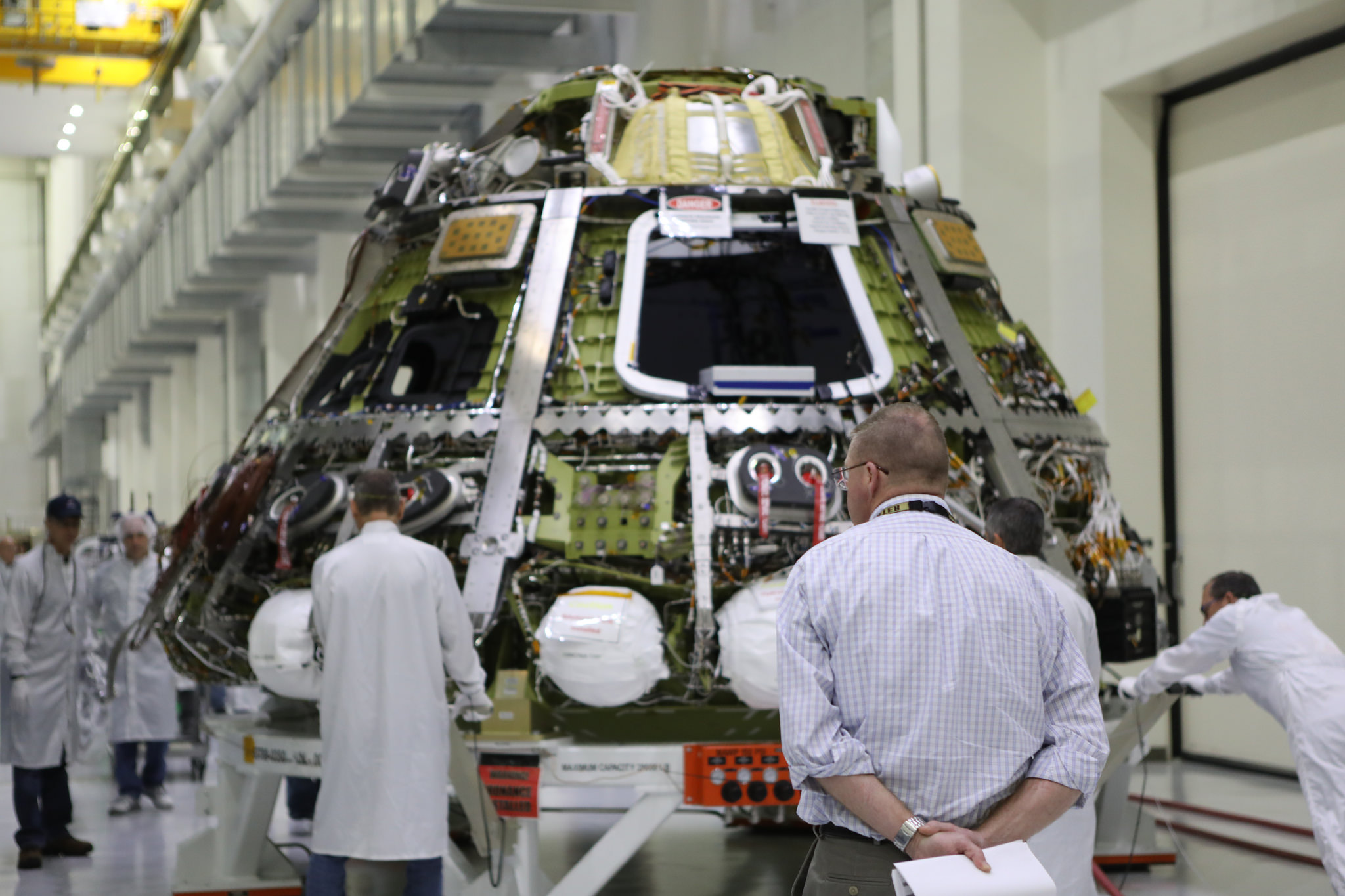 The Orion crew module for EM-1 is moved toward the thermal chamber in the Operations and Checkout Building.