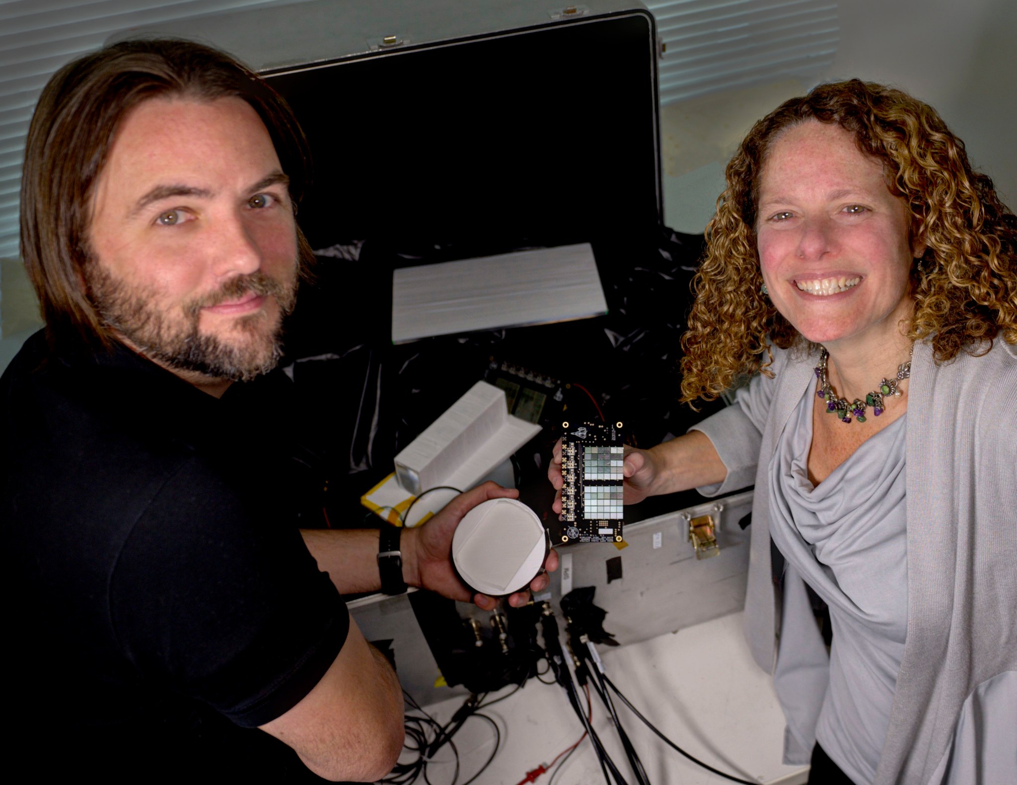 PI's Jeremy Perkins and Georgia de Nolfo hold technology for CubeSat mission