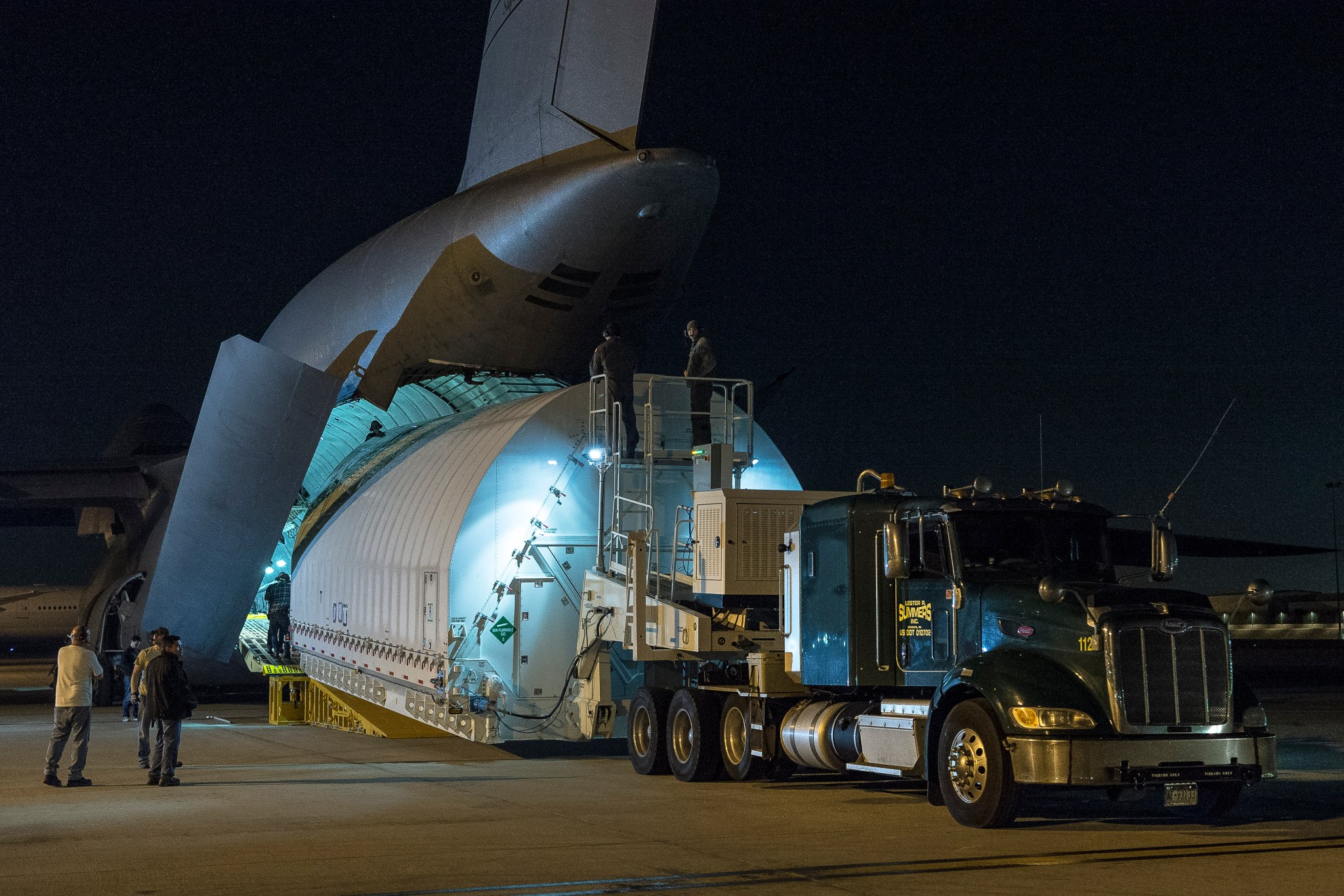 James Webb Space Telescope, is unloaded from a U.S. military C-5 Charlie aircraft at Los Angeles International Airport