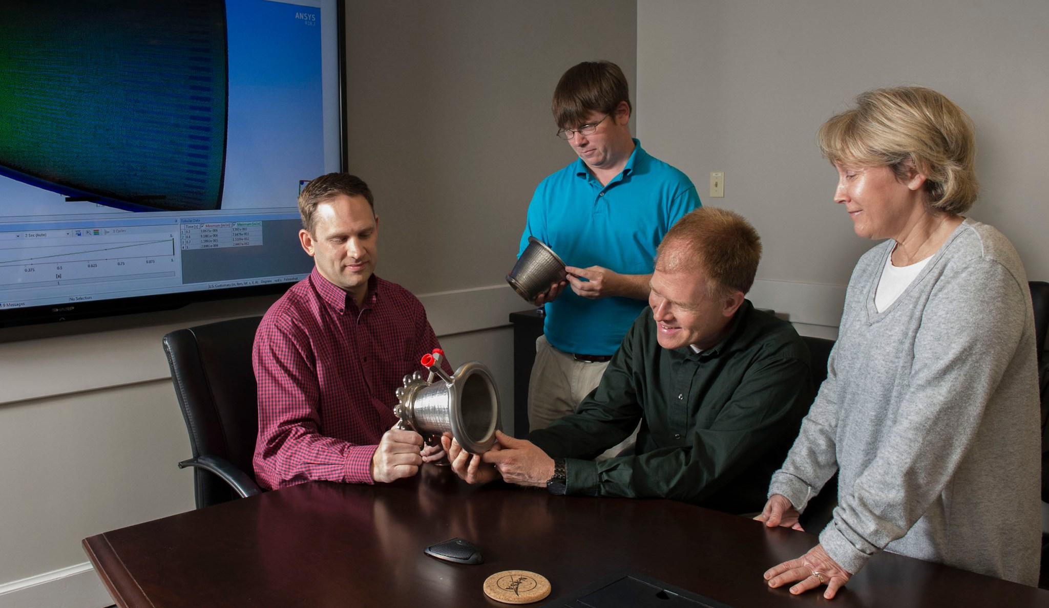 Engineers from NASA Marshall's Propulsion Department examine nozzles fabricated using a freeform-directed energy wire deposition