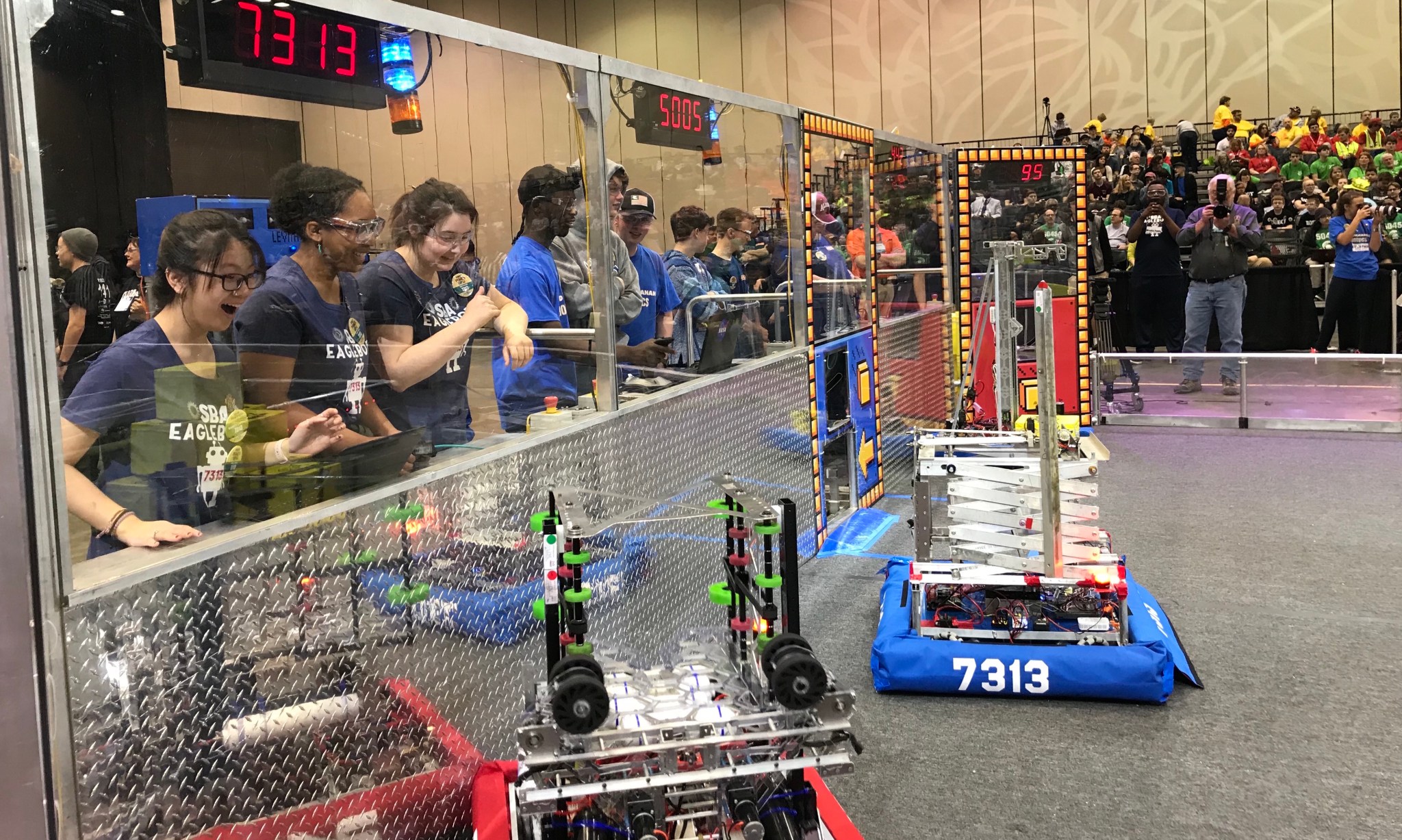 SBA Eaglebots from Cordova, Tennessee, at left in navy, March 16 at the FIRST Robotics Rocket City Regional.