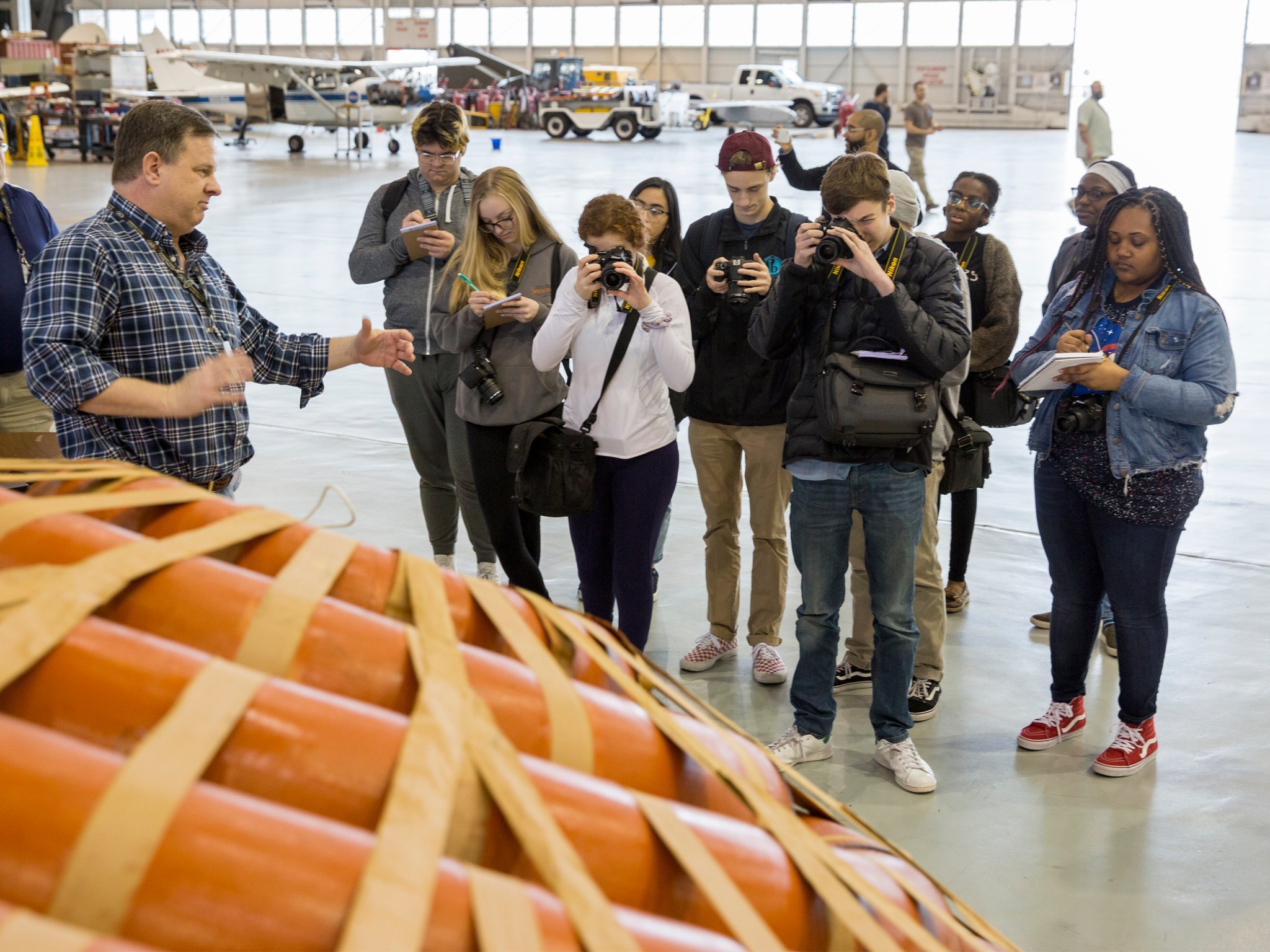 Green Run Collegiate High School students photograph a HIAD (Hypersonic Inflatable Aerodynamic Decelerator) model.