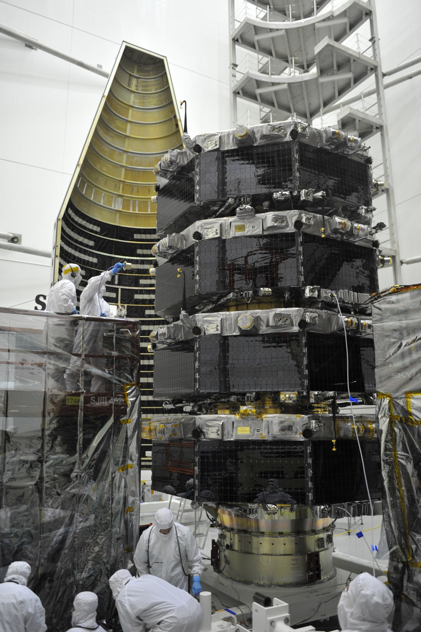 On the scissor lift conducting an RF antenna verification test during KSC launch operations (holding a pickup antenna).   