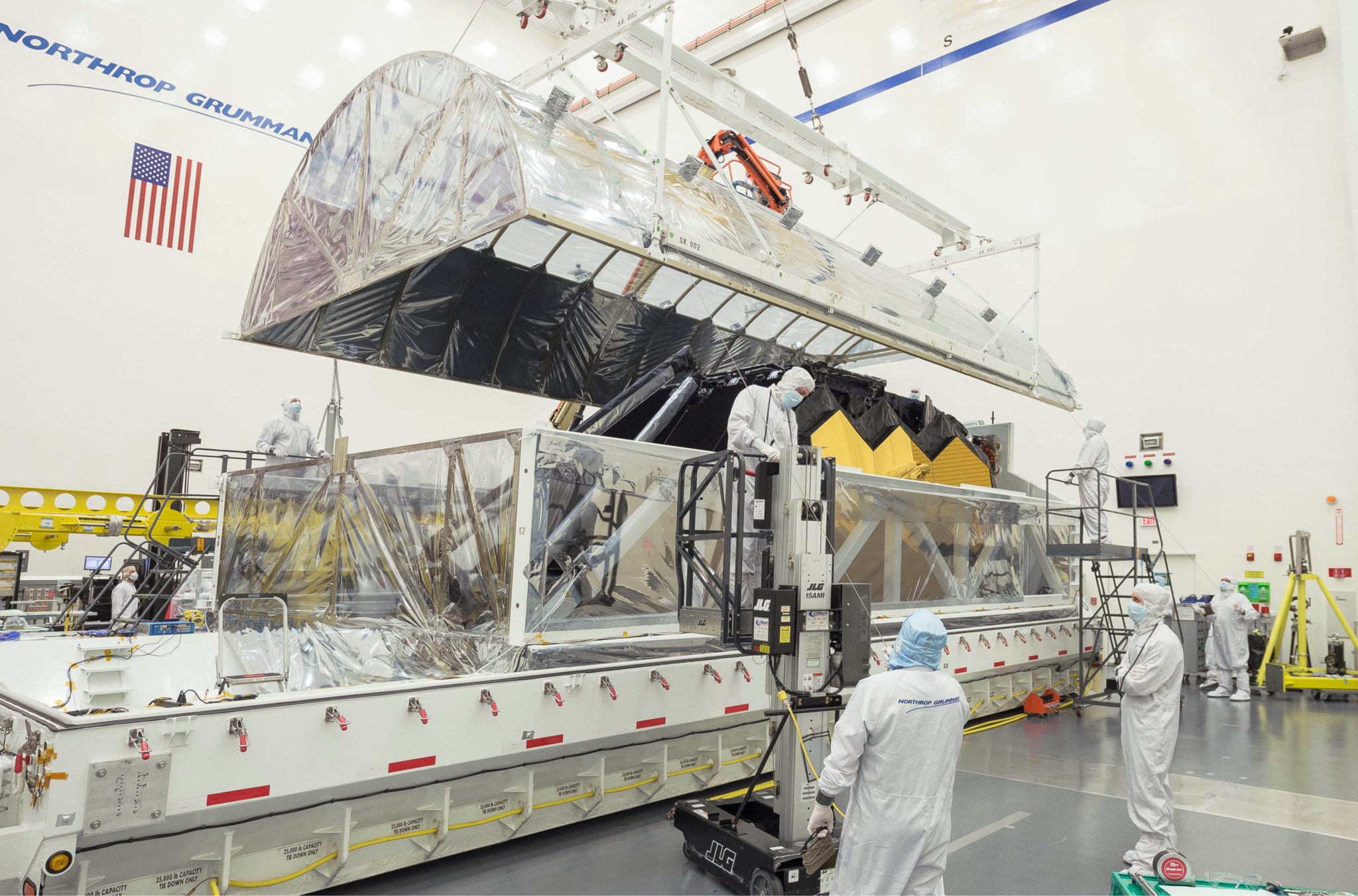 Engineers open the interior tent frame of the Space Telescope Transporter for Air, Road and Sea (STTARS) at Northrop Grumman.