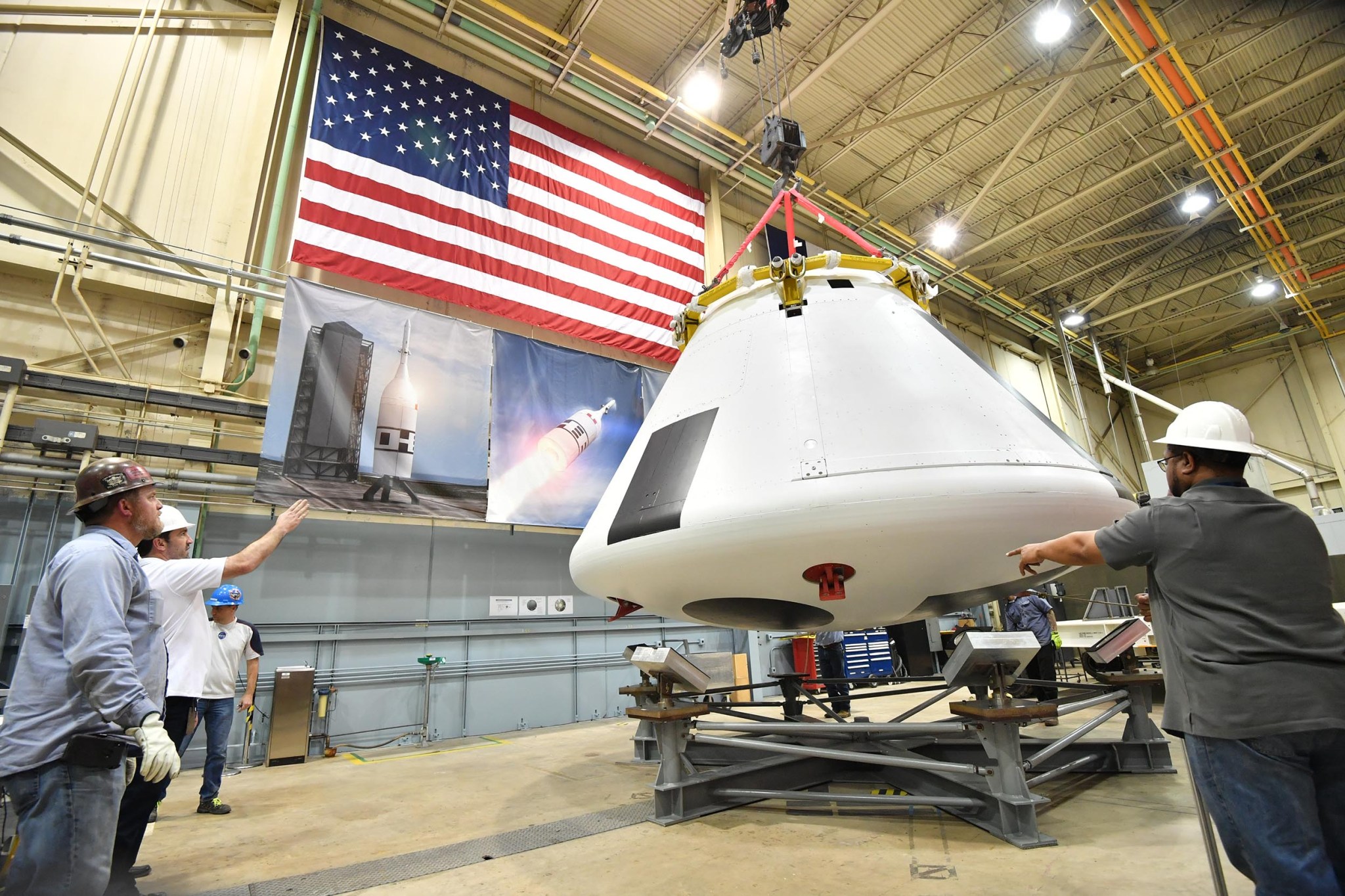 Technicians lower the crew module for Ascent Abort-2 onto a stand at Johnson Space Center in Houston on March 2.