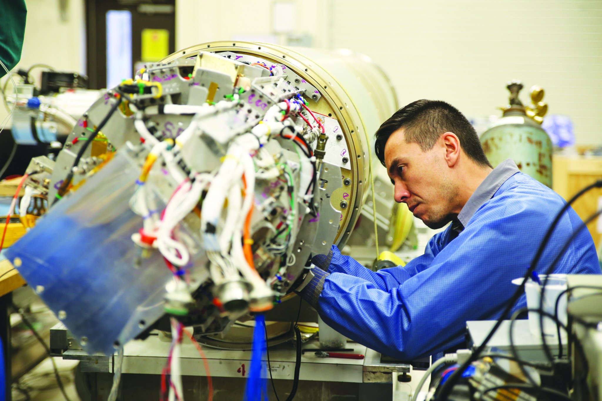 A technician working inside of a sounding rocket payload.