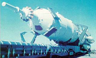 Rollout of a Zond spacecraft atop its Proton booster at the Baykonur Cosmodrome.