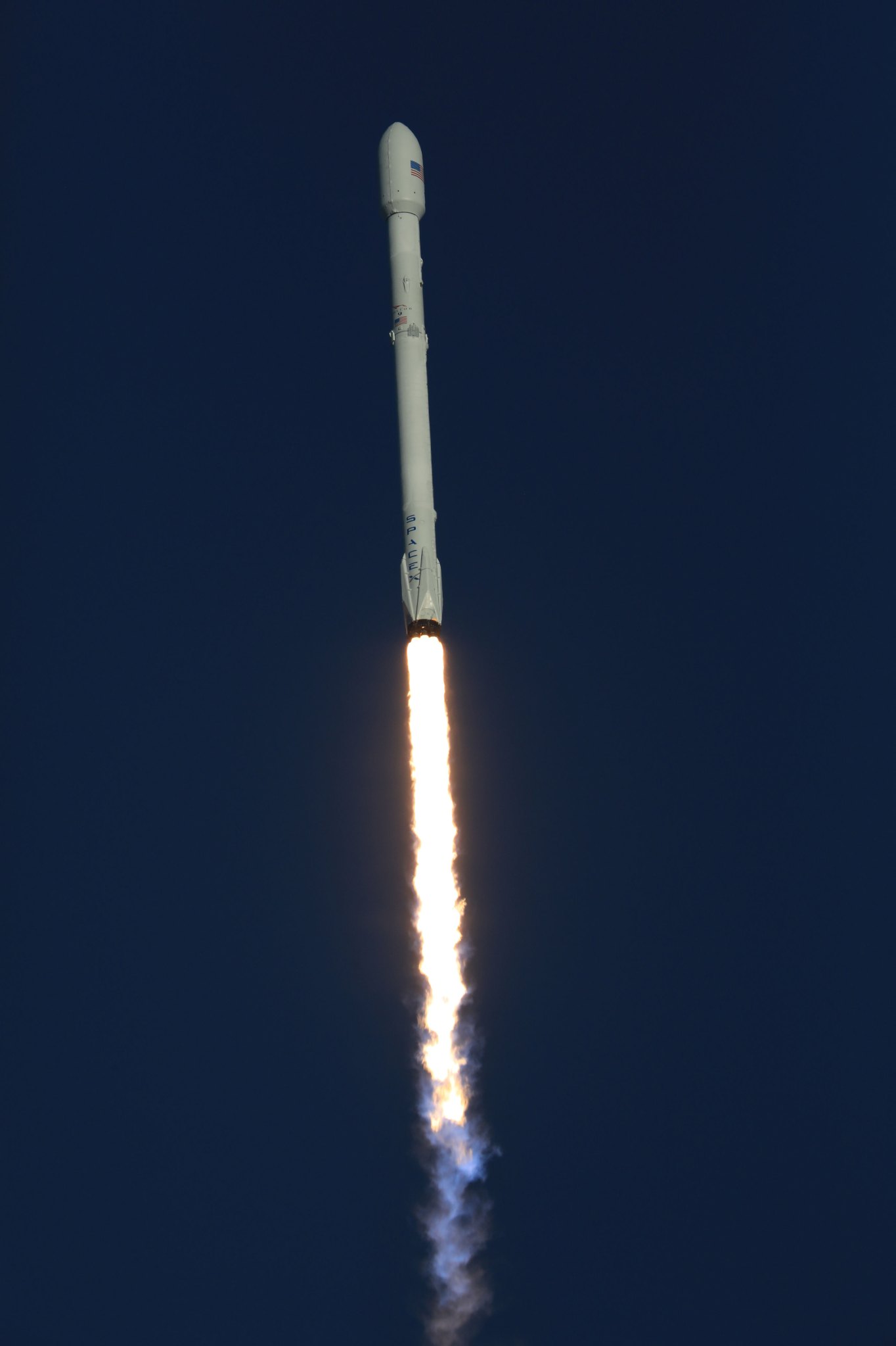 Falcon 9 rocket with NASA TESS spacecraft aboard streaks upward through sky