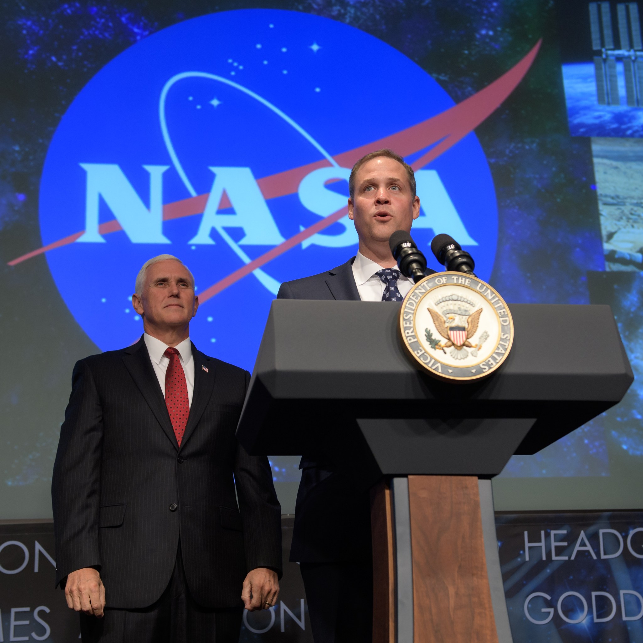 Administrator Bridenstine speaks at podium with Vice President Pence at left