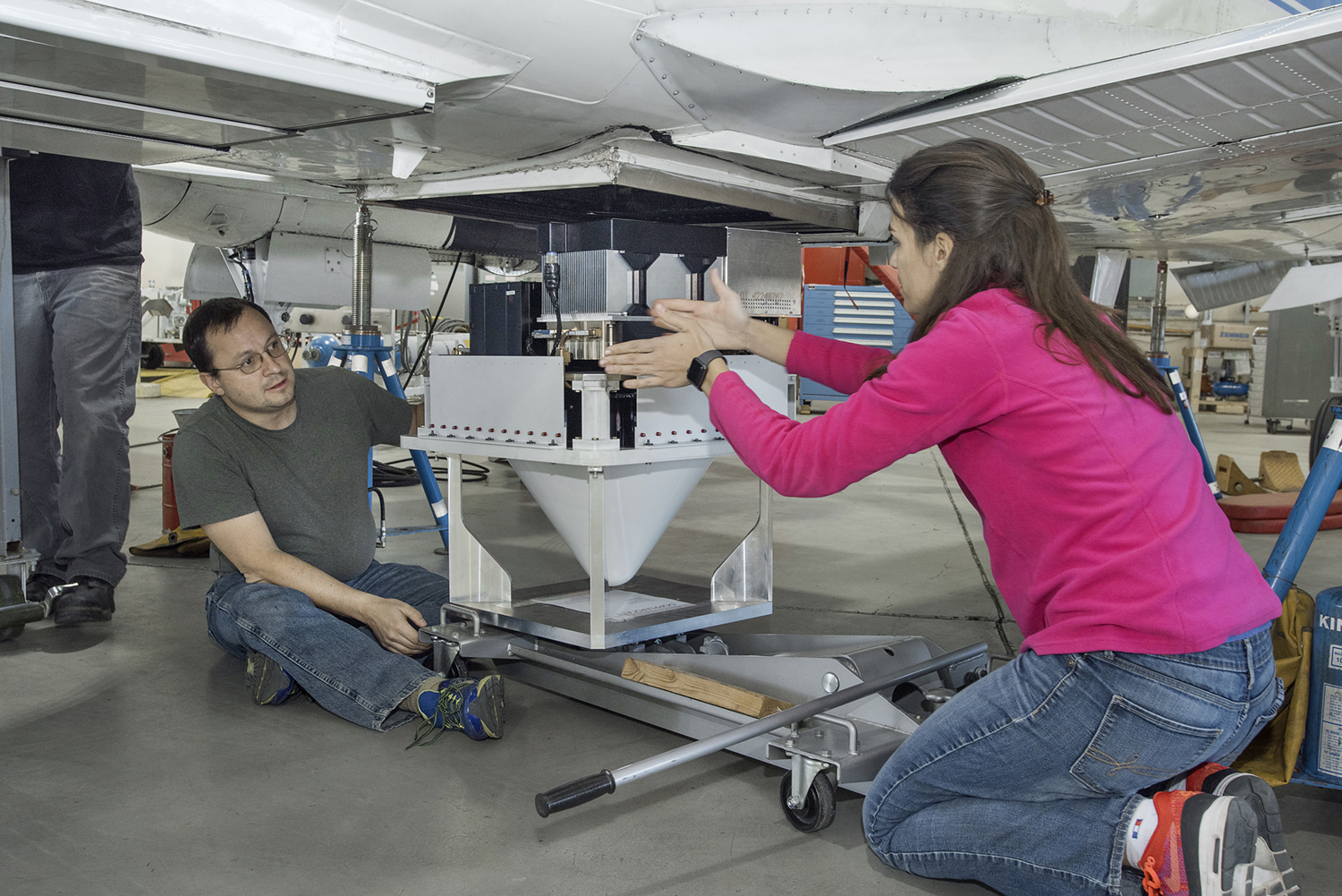 Engineers discuss placement of the DopplerScatt radar instrument on the NASA B200 