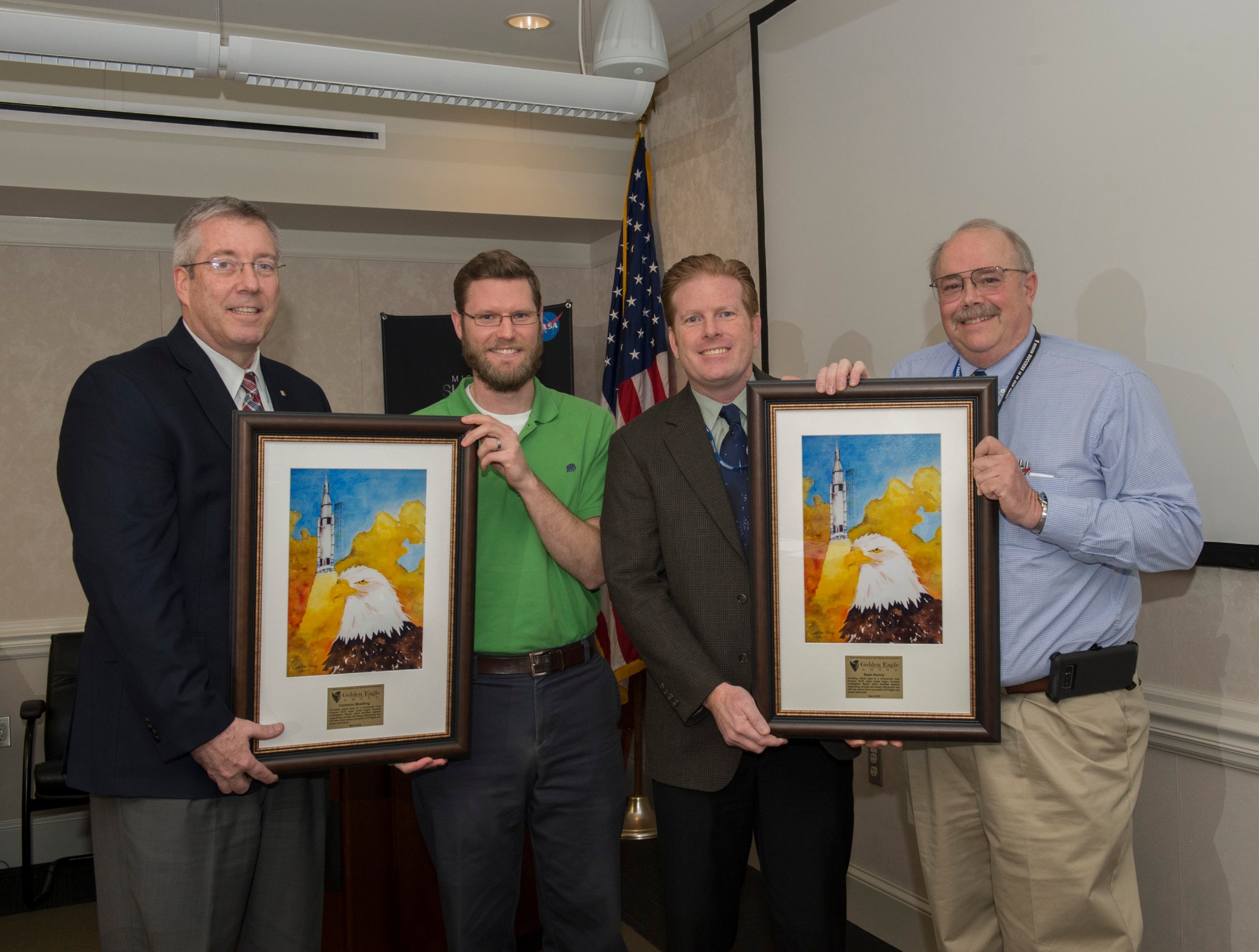 Cameron Muelling and Sean Kenny receive the Golden Eagle award from Rick Burtand Jeff Haars.