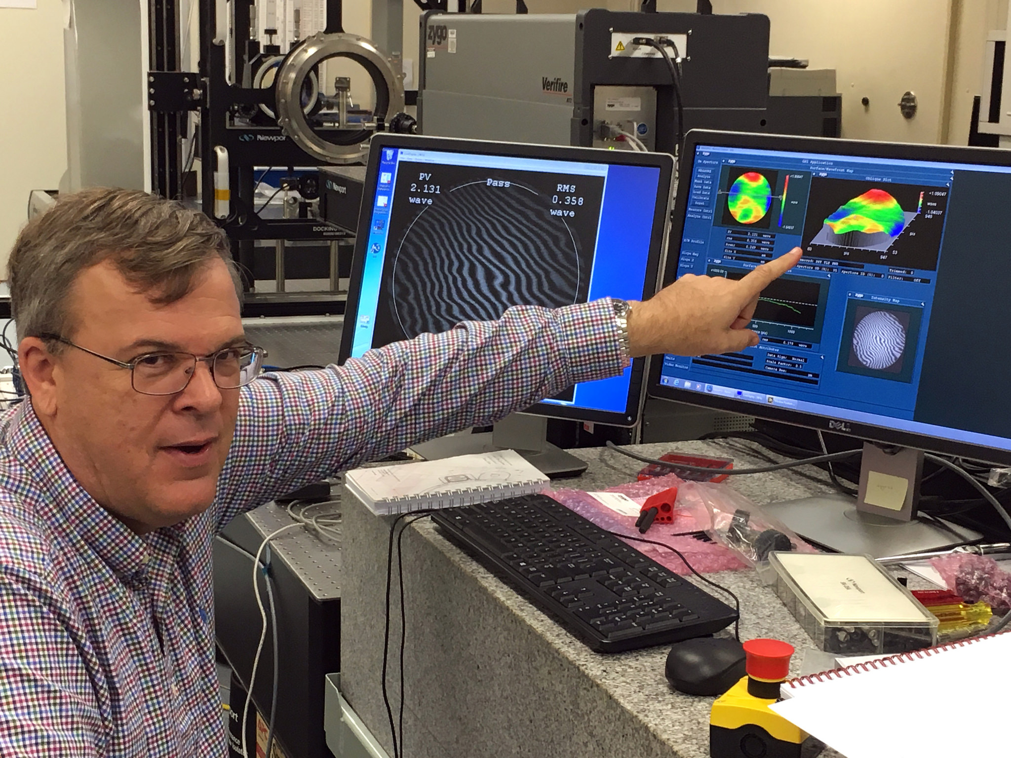 Mark Nurge looks at data during the first optical quality test on a full window stack that is ready for installation on Orion.