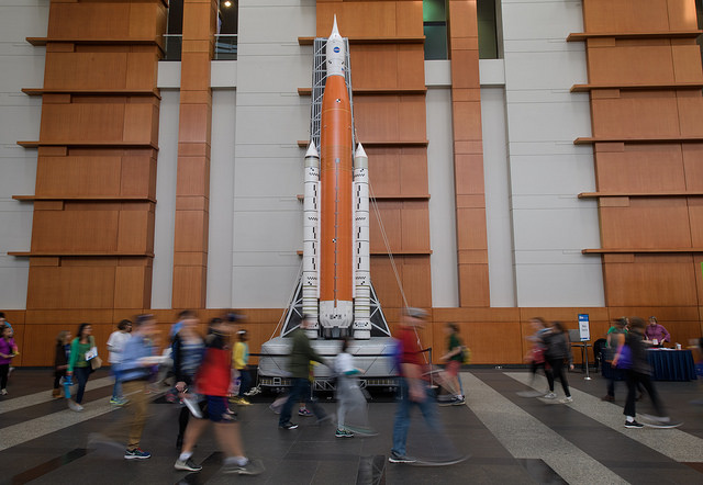 Attendees walk past an inflatable model of NASA's Space Launch System at the USA Science and Engineering Festival April 6.