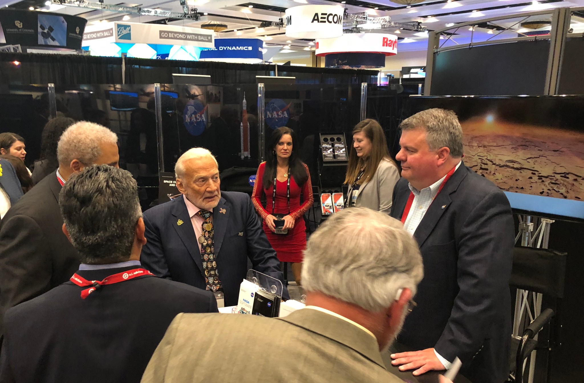 Former NASA astronaut Buzz Aldrin, center, talks with Terry Taylor at the 34th Space Symposium in Colorado Springs, Colorado.