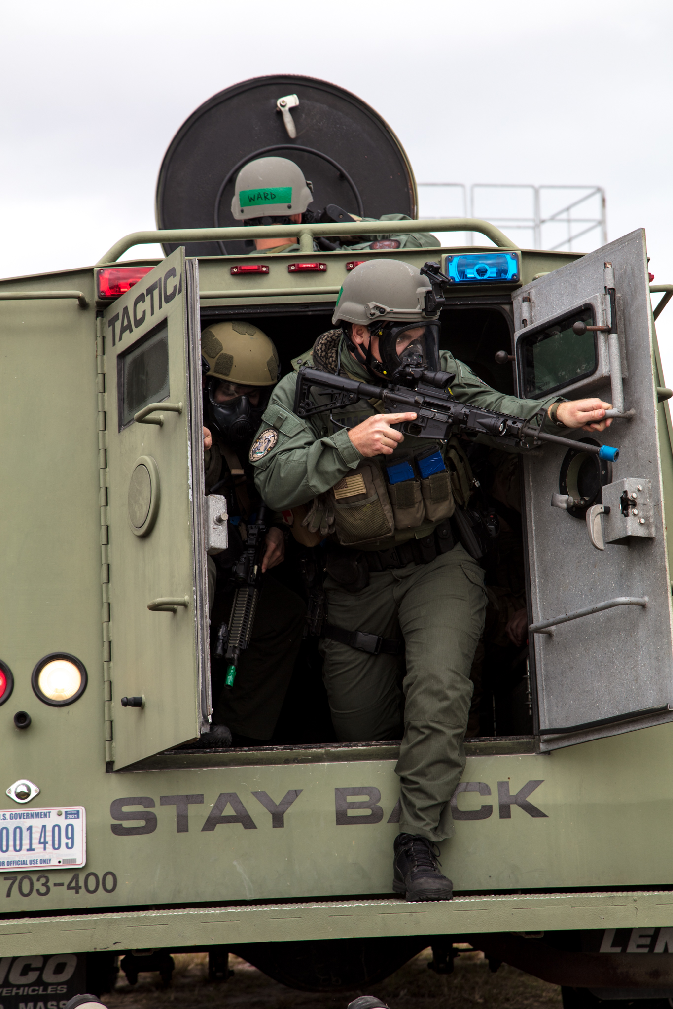 Emergency Response Team members exit a vehicle during a training exercise.