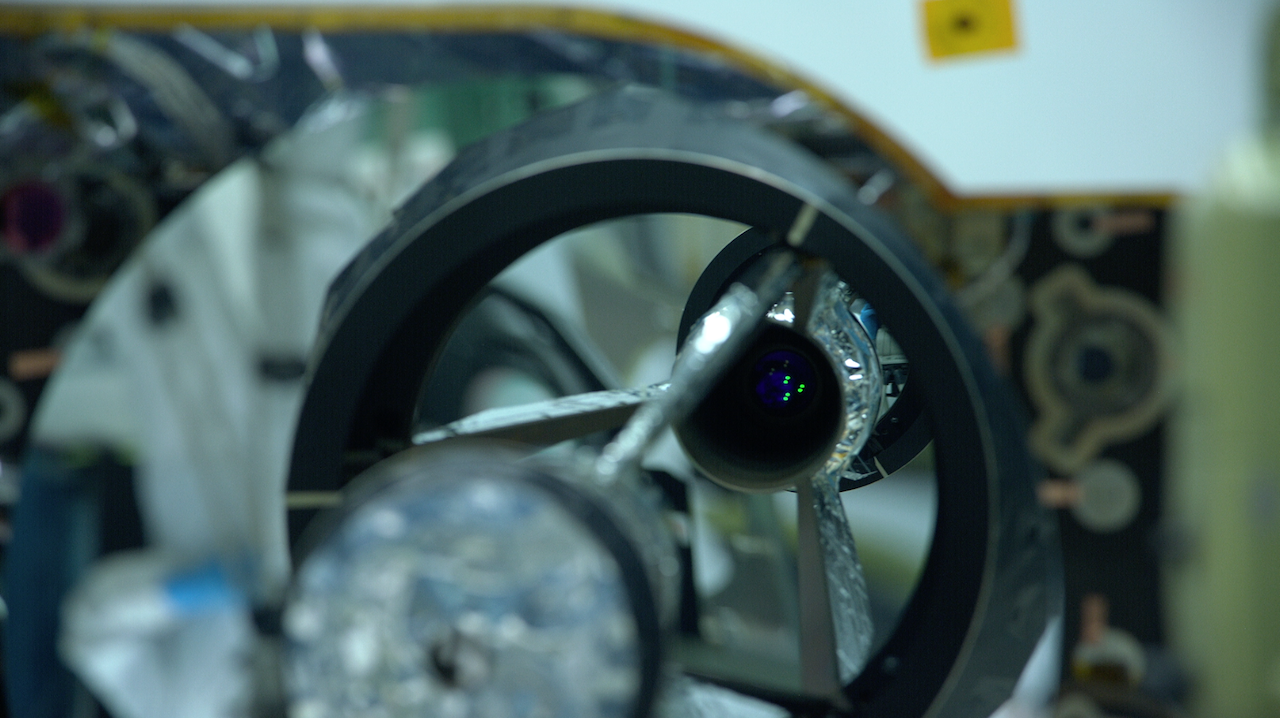 A close up shot of the GEDI instrument in the clean room, looking at the laser. Six green dots are visible.