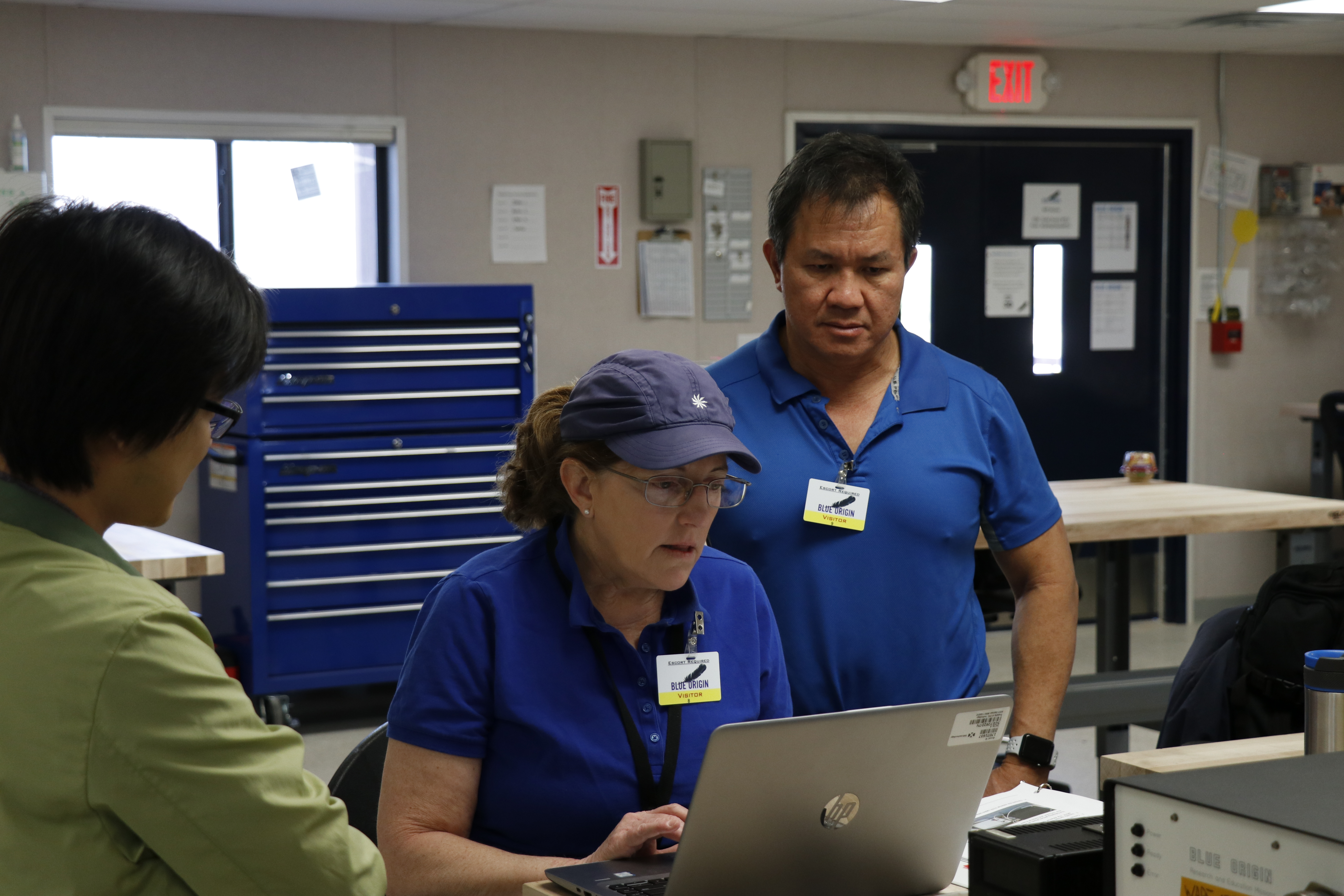 SFEM-2 Katy Hulbert, principal investigator, center, and team members Alex Kim, right, and Hiep Nguyen prepare the experiment fo