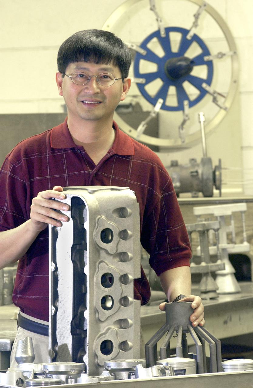 Man with Large Metal Parts in front of him