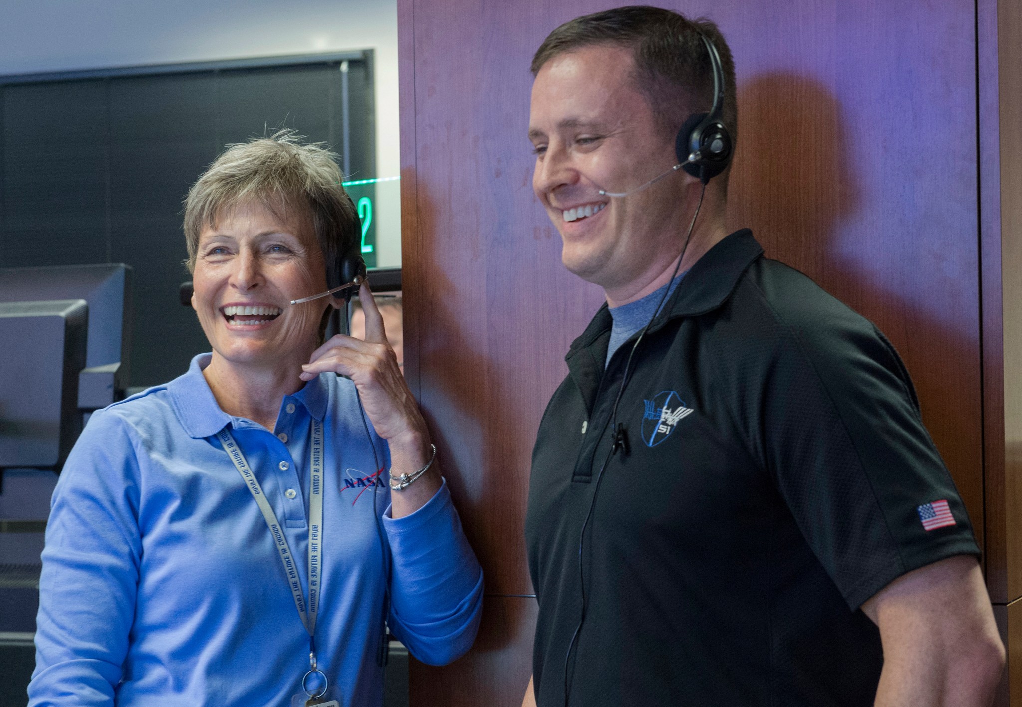 Astronauts Peggy Whitson, left, and Jack Fischer speak with ISS crew members while visiting the POIC Oct. 12. 