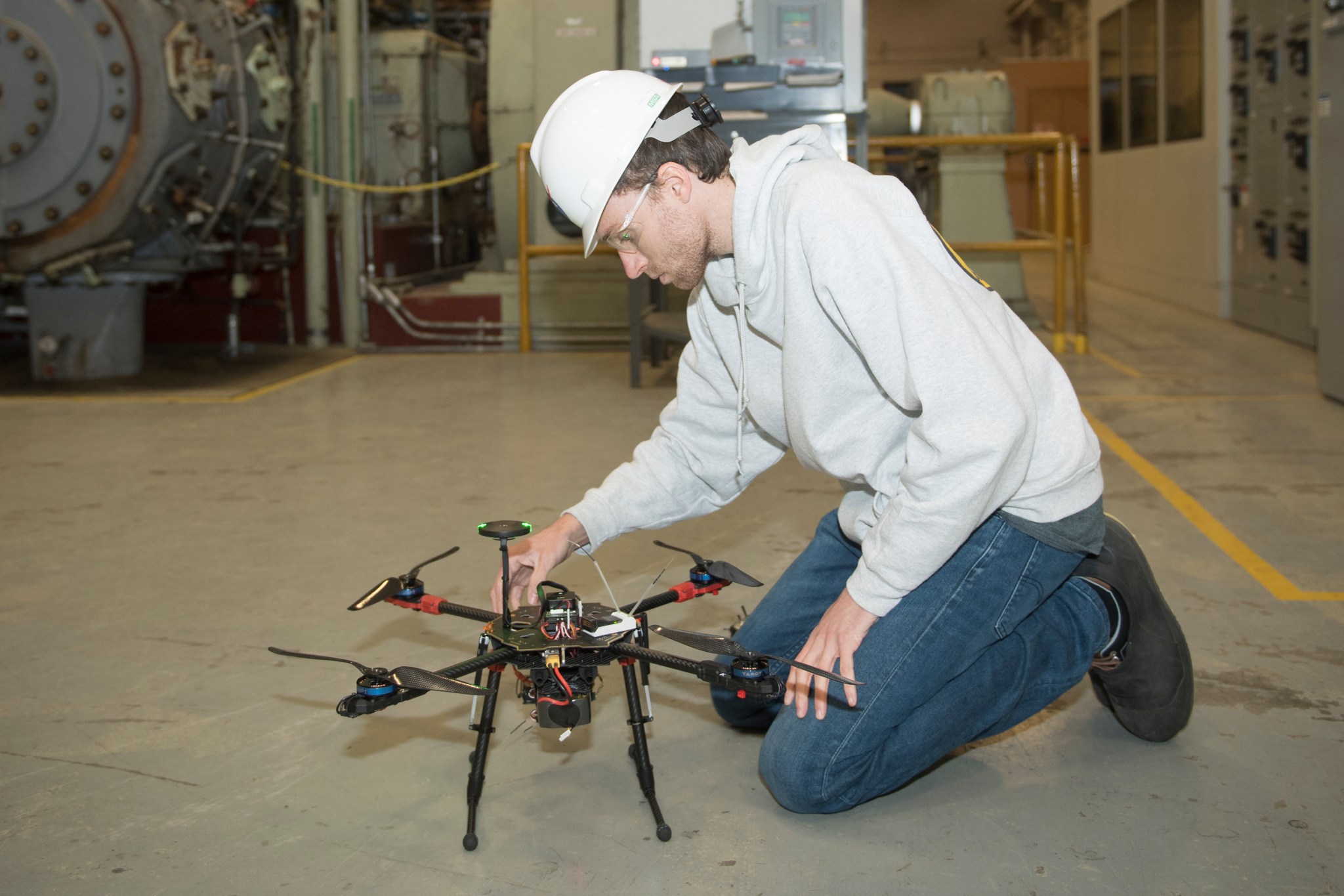 Unmanned aerial vehicles pilot Zak Johns readies the drone for flight at NASA's Langley Research Center. 