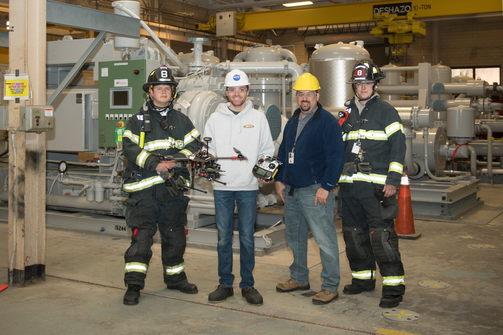 From left, NASA Langley firefighters Tim Mitchell and Seth Everett flank drone pilot Zak Johns and photographer Harlen Capen.