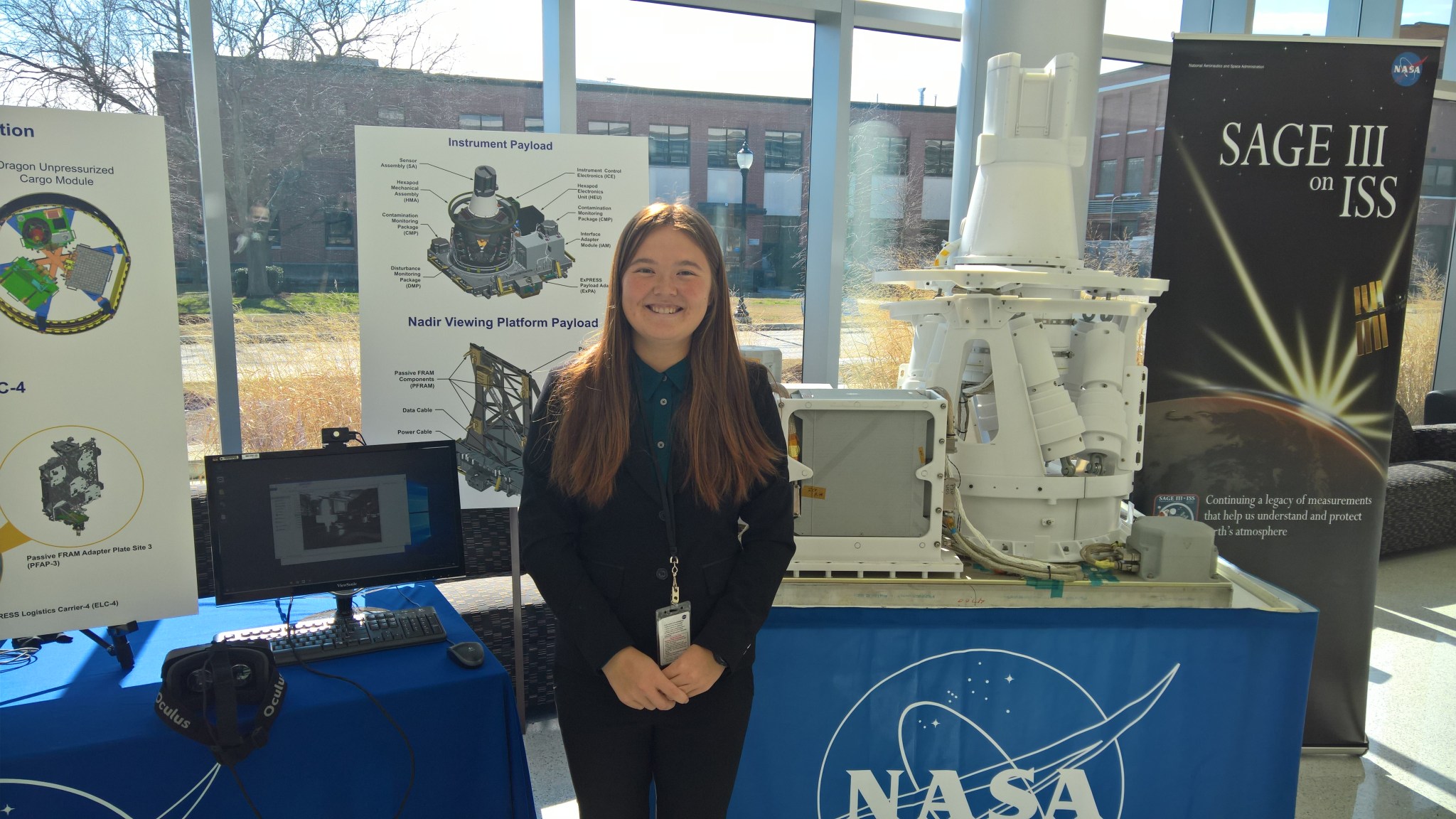 Christine Odenwald poses with a SAGE III on ISS display at NASA Langley.