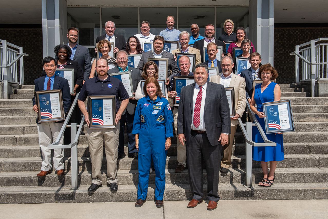 Silver Snoopy honorees gather July 18 with astronaut Shannon Walker, foreground left; and Marshall Center Director Todd May, for