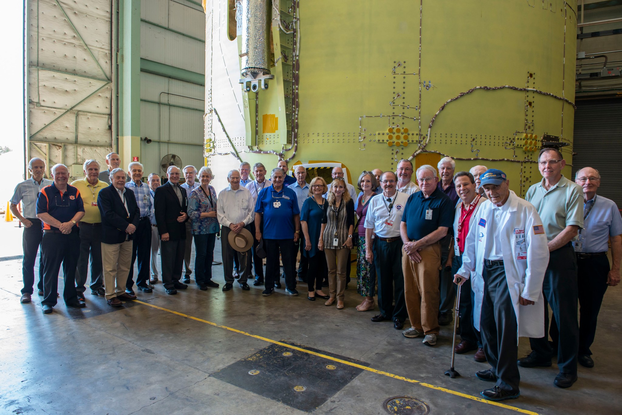 Marshall Retirees Association members take a break in front of the intertank for NASA's new rocket, the Space Launch System.